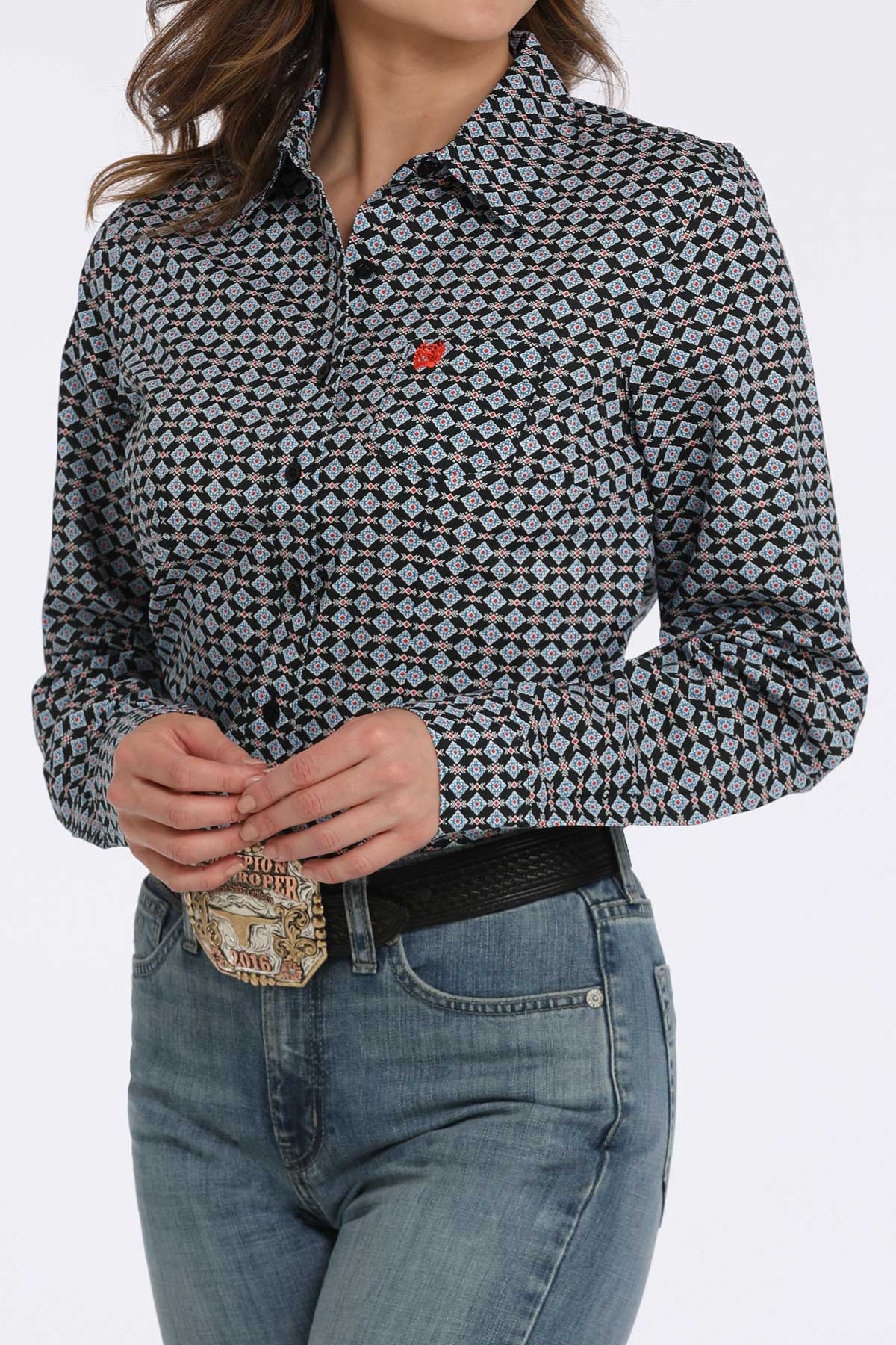 Person wearing a patterned shirt and jeans on a white background