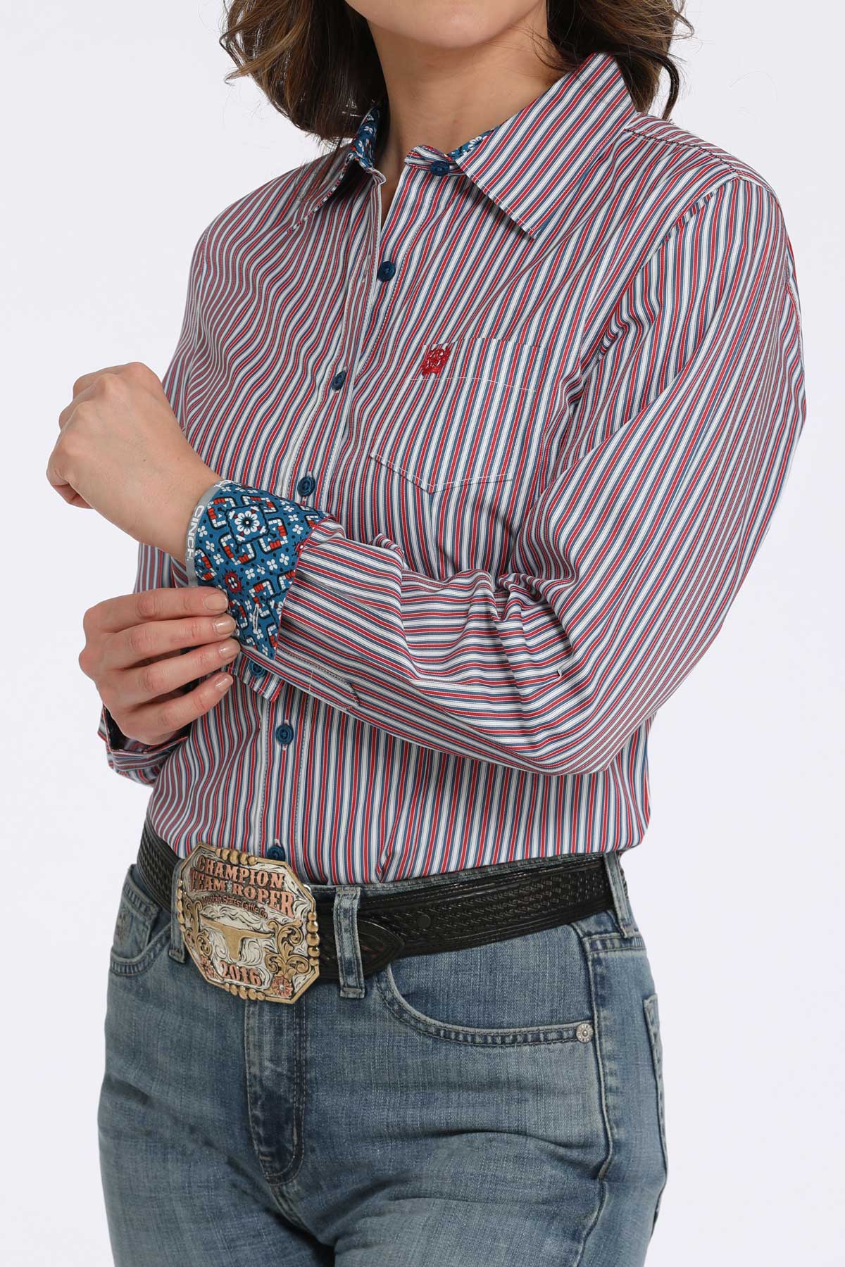 Person wearing a striped shirt with rolled-up sleeves and jeans on a white background