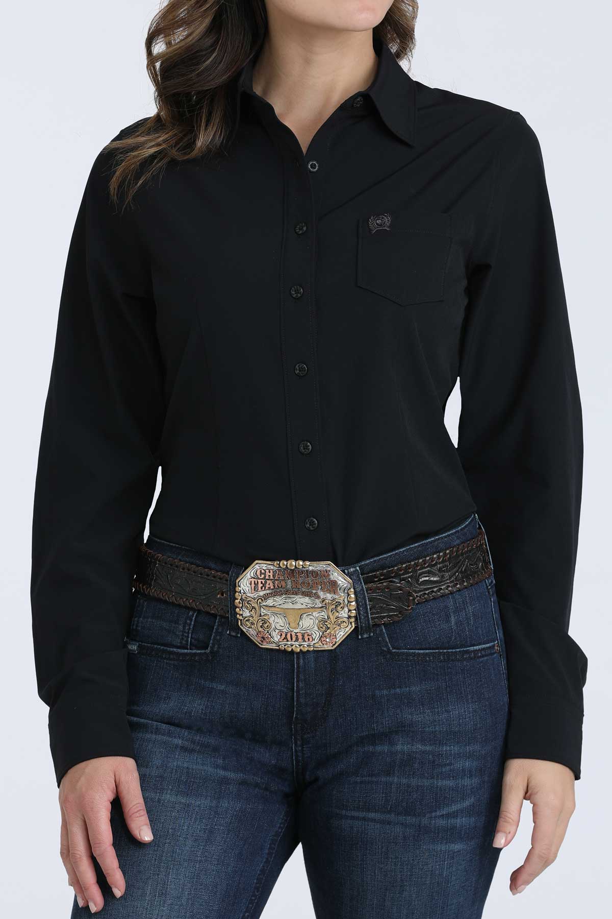 Person wearing a black shirt and blue jeans with a decorative belt on a white background