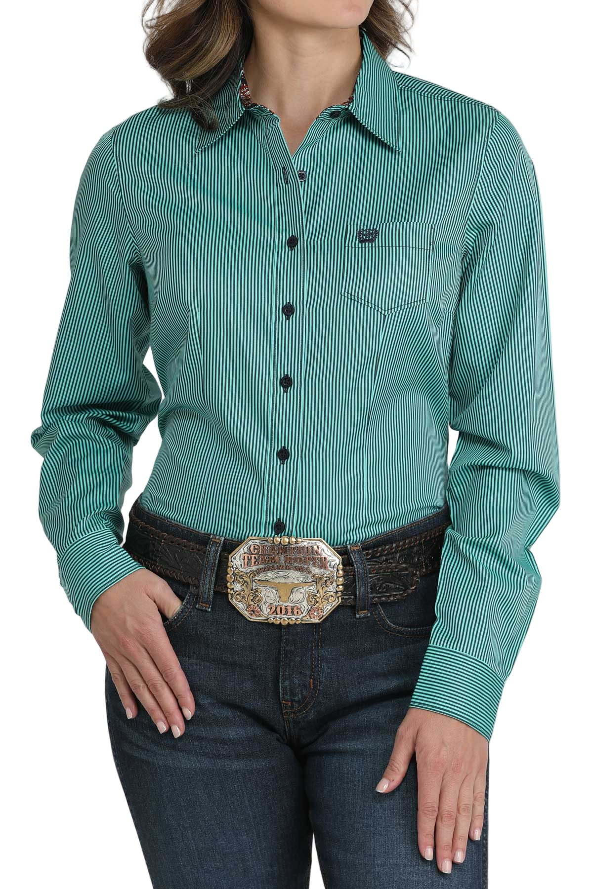 Woman wearing a teal striped button-down shirt, paired with dark jeans and a large western belt buckle