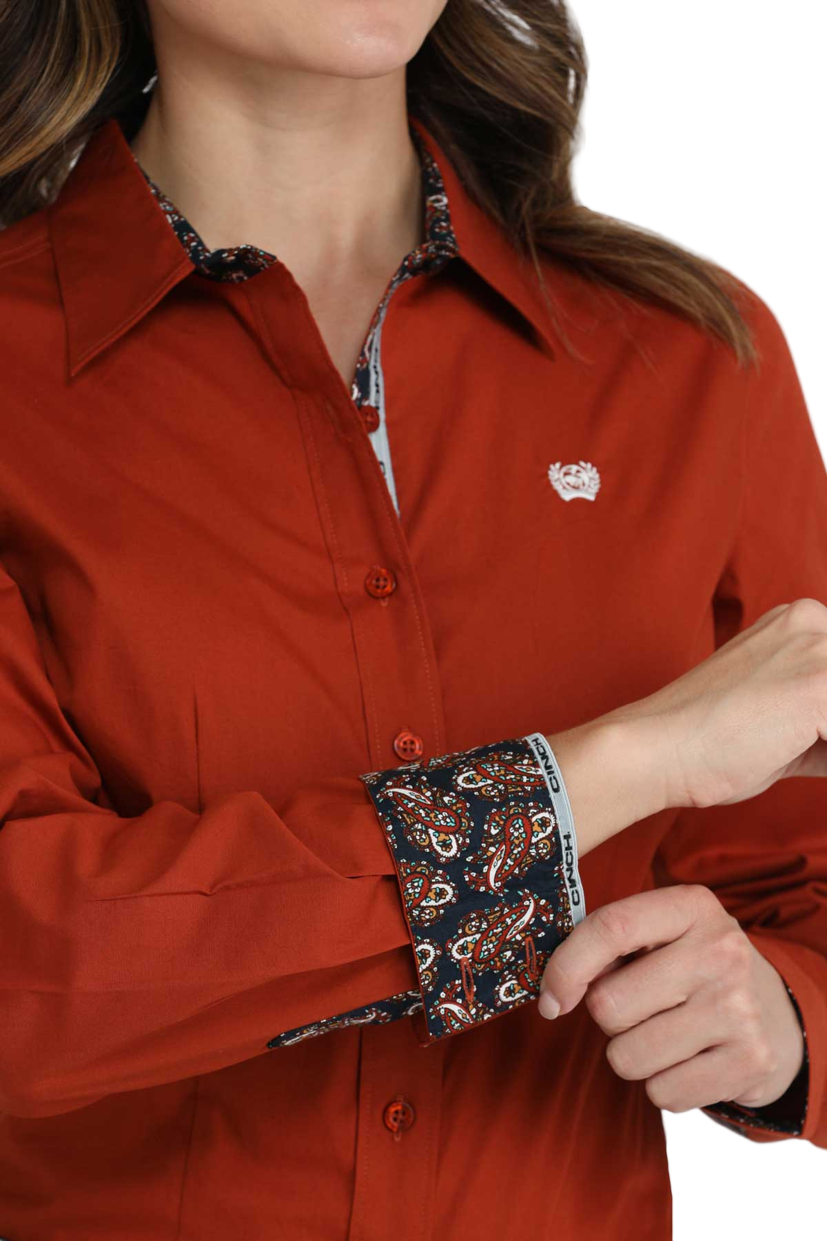 Close-up of a woman wearing a red long-sleeve button-down shirt with contrasting cuffs