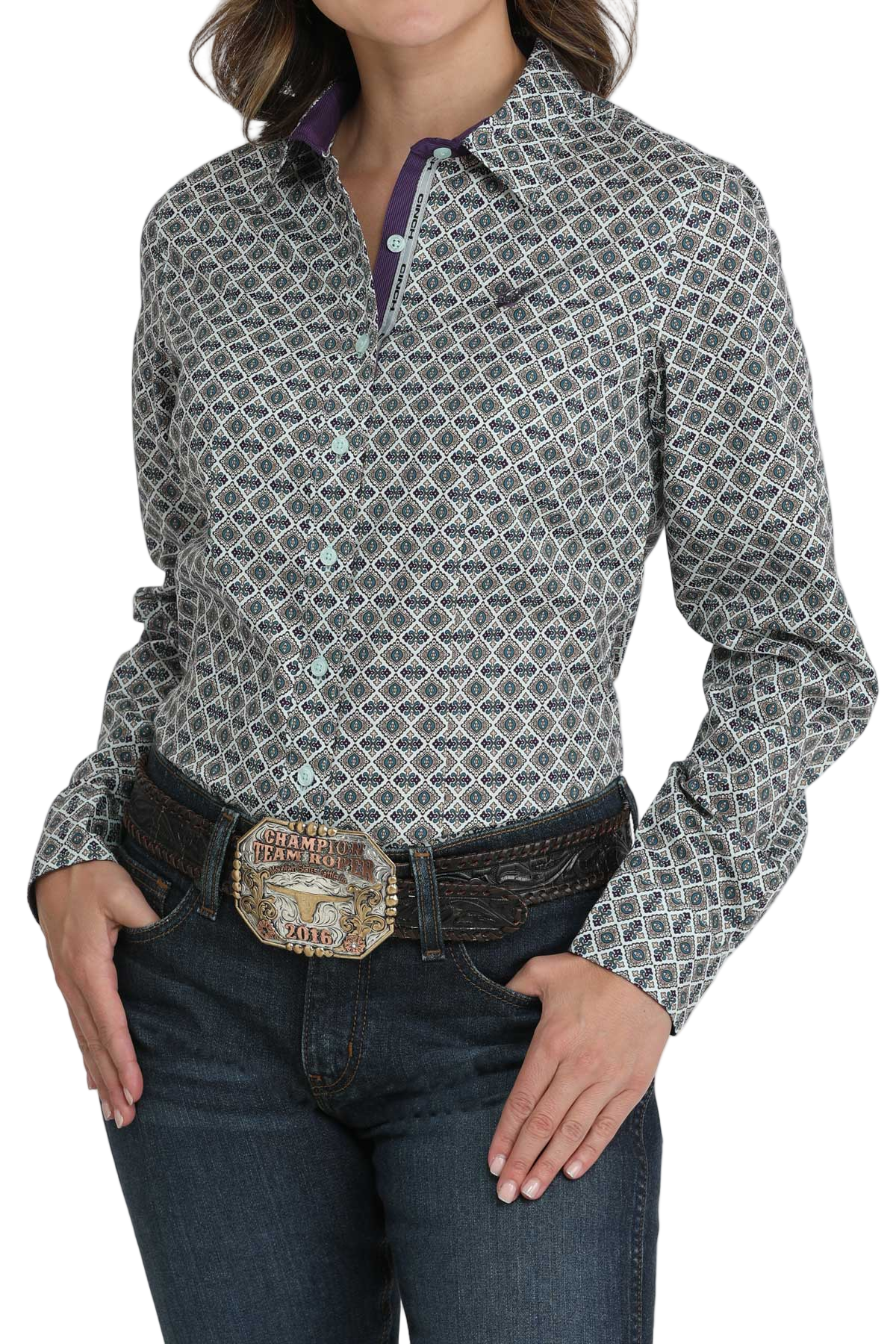 Woman wearing a patterned button-down shirt with purple contrast cuffs and collar trim, paired with jeans