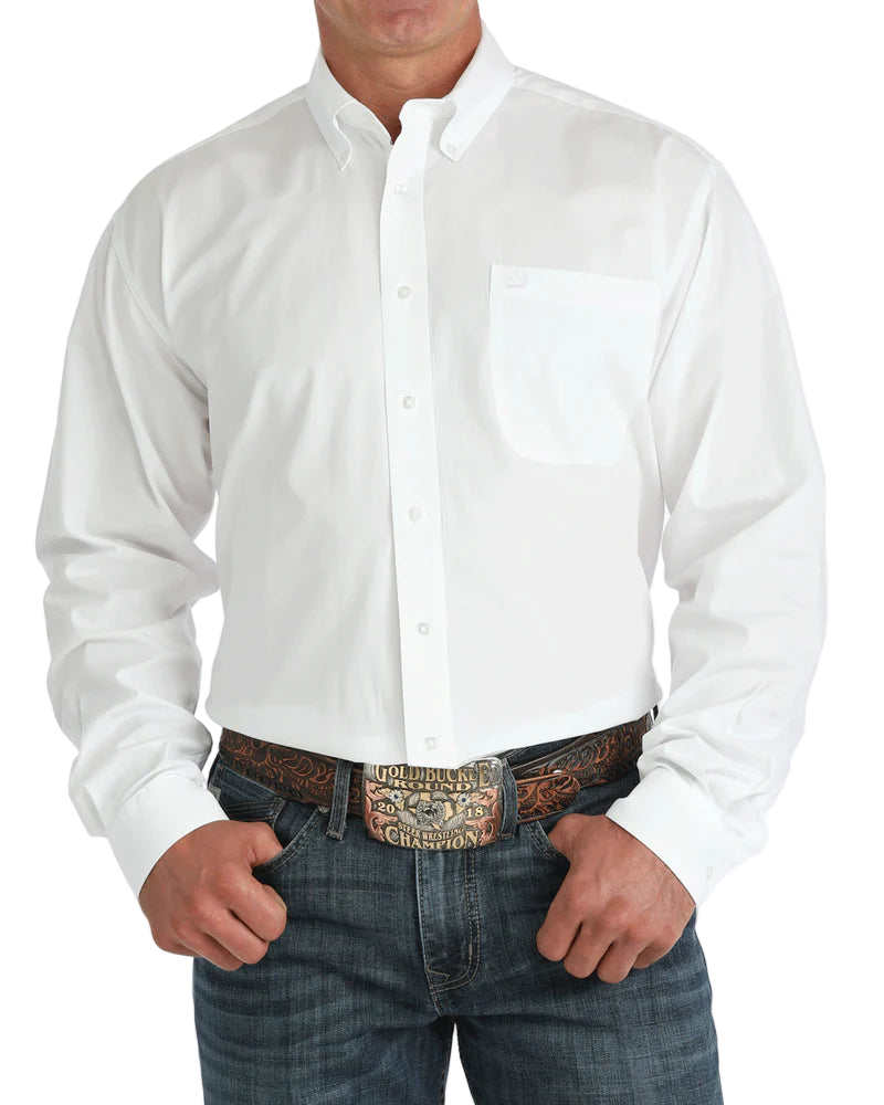 Man wearing a white button-up shirt with blue jeans on a white background