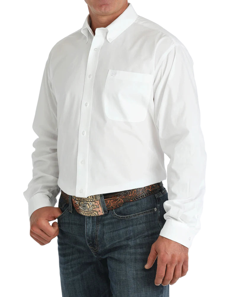 Man wearing a white button-up shirt with blue jeans on a white background