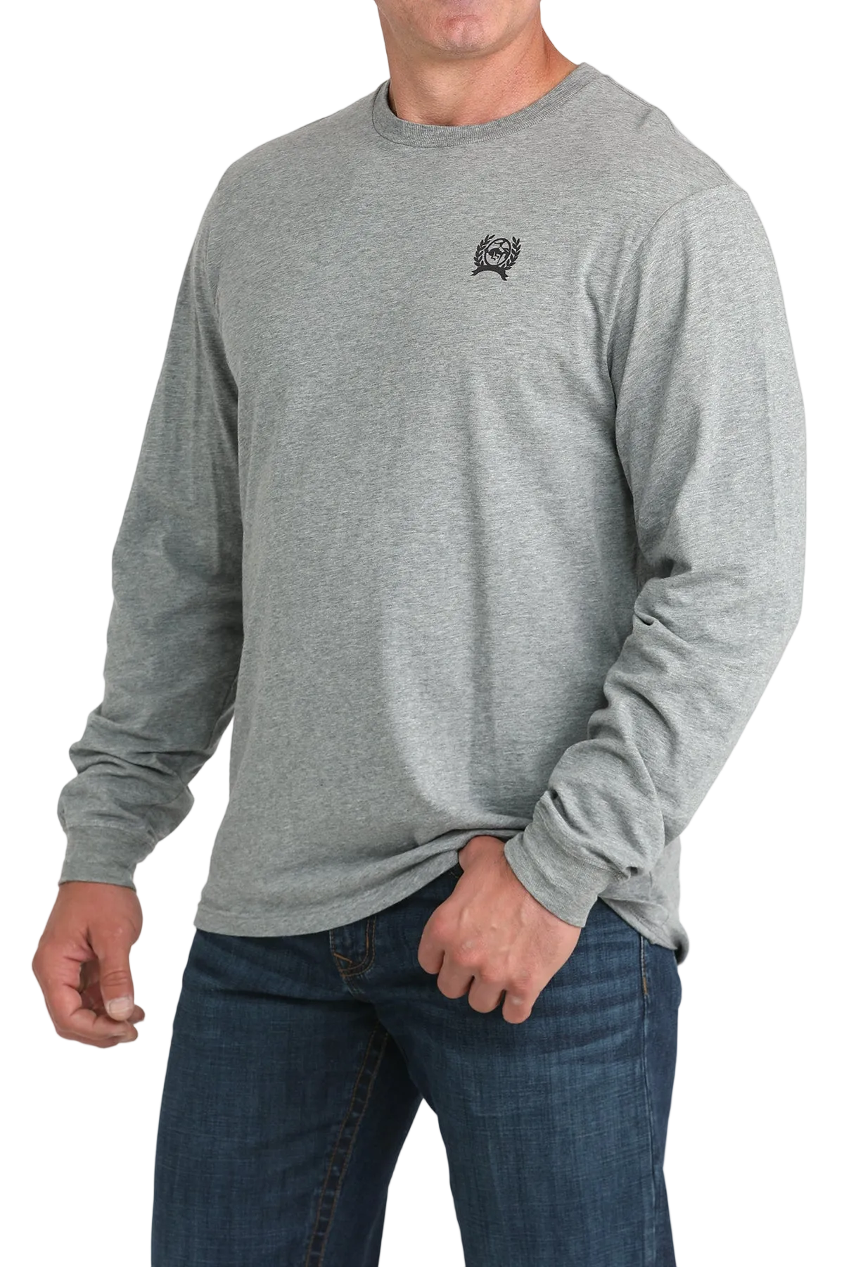 A man wearing a gray long-sleeve shirt and dark jeans stands against a transparent background.