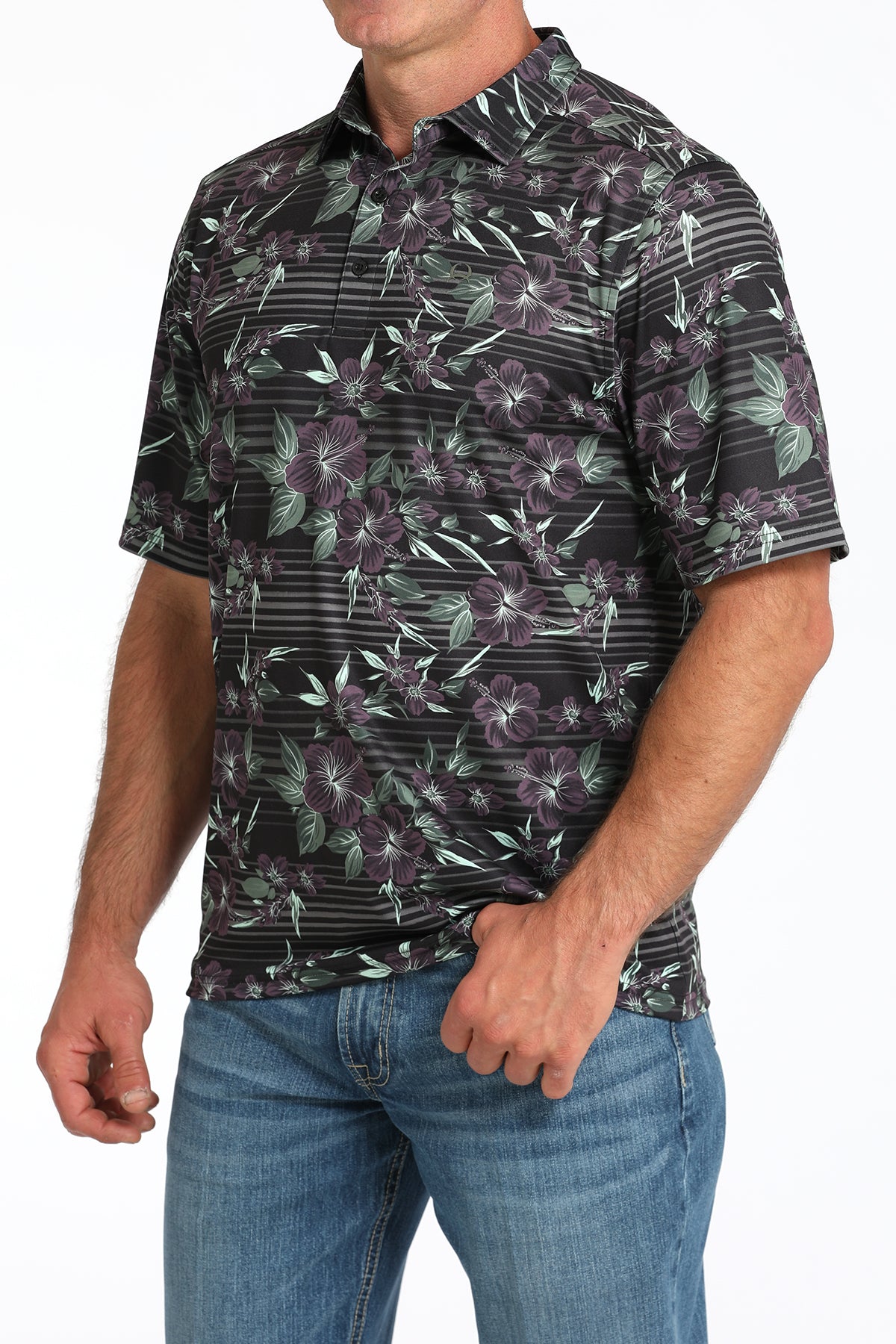 Man wearing a patterned shirt with floral and geometric design on a white background
