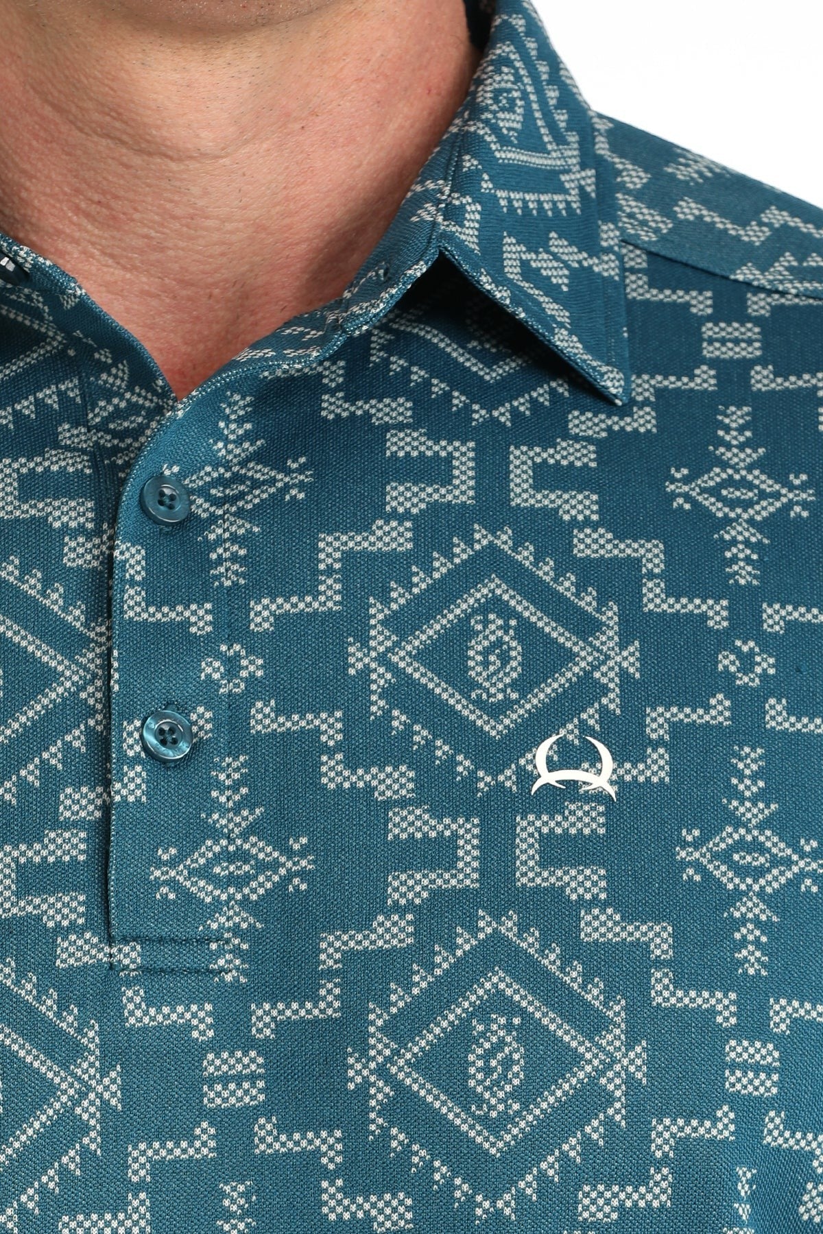 Go West Supply Men's teal short sleeve polo with white geometric pattern and embroidered logo.