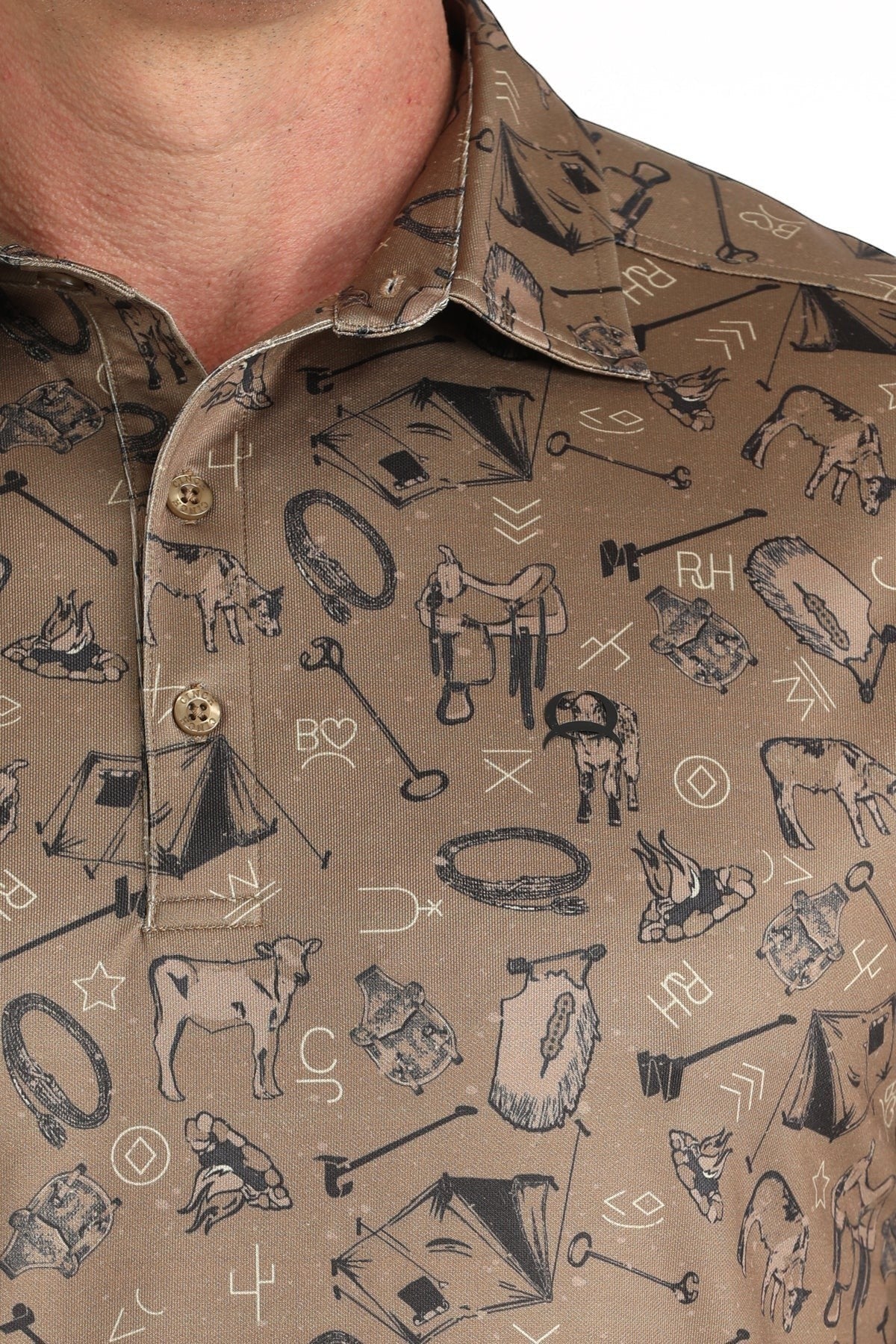 Go West Supply brown ArenaFlex polo with all-over cowboy print, featuring tents, saddles, cattle, and branding symbols. Short sleeves and classic collar.