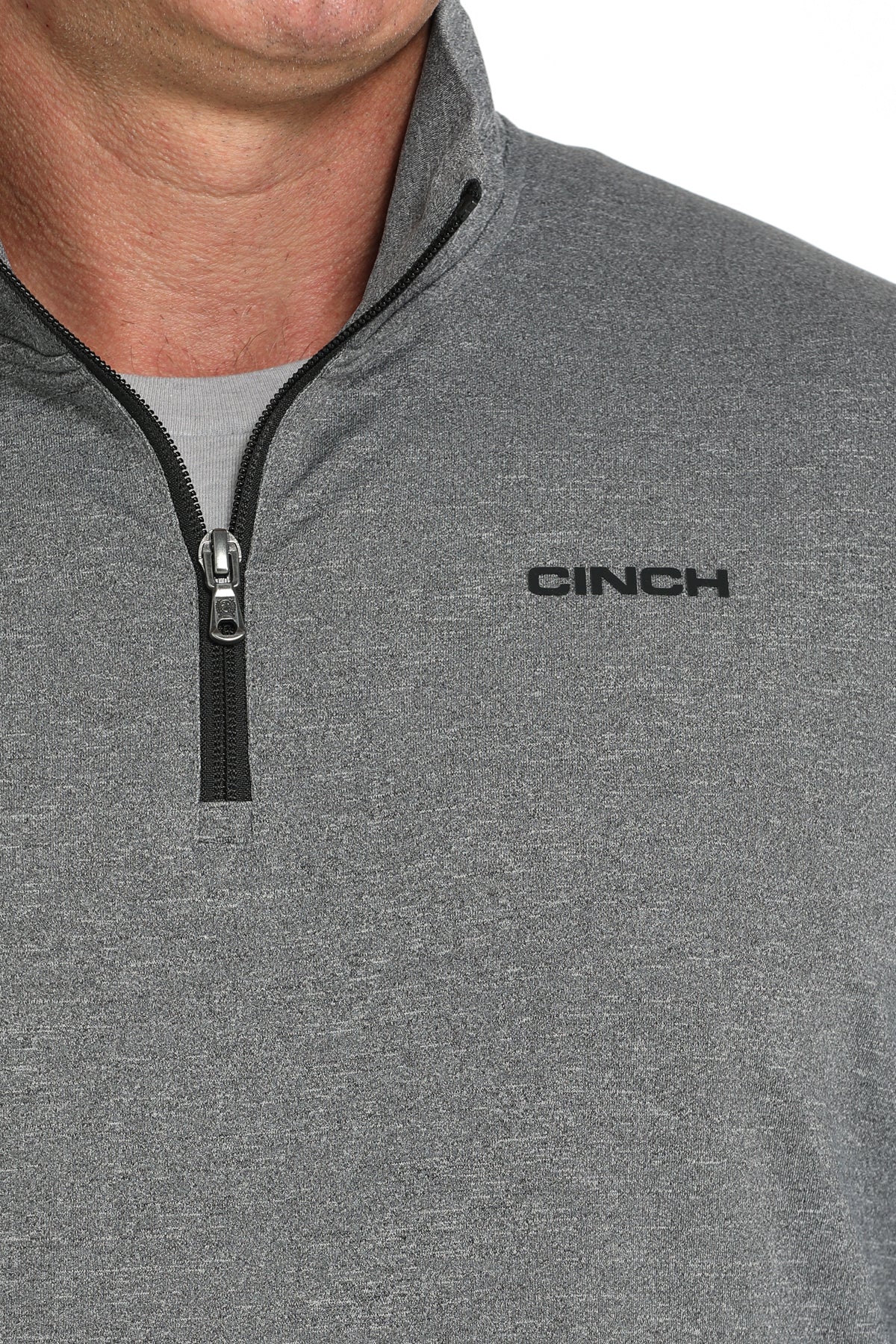 Close-up view of a gray CINCH quarter-zip pullover with a black zipper and logo displayed on a white background.