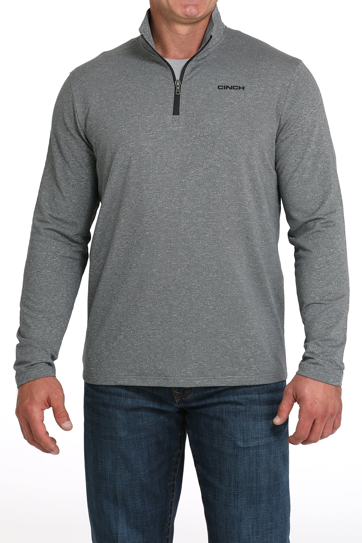 Man wearing a gray long-sleeve shirt with a quarter zip and blue jeans on a white background