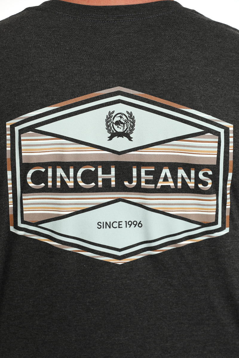 Close-up, back view of a man wearing a dark gray t-shirt with a large 'Cinch' logo on it on a white background