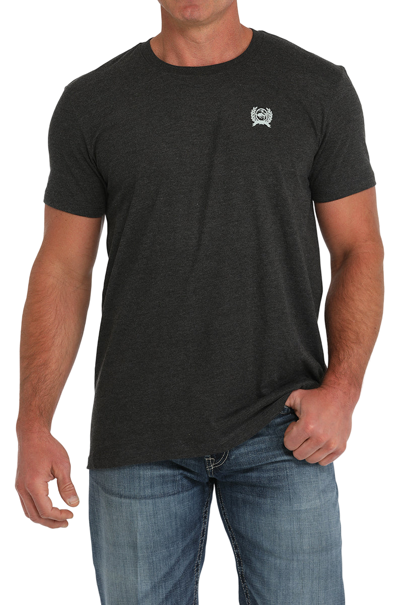 Man wearing a dark grey t-shirt with jeans on a transparent background