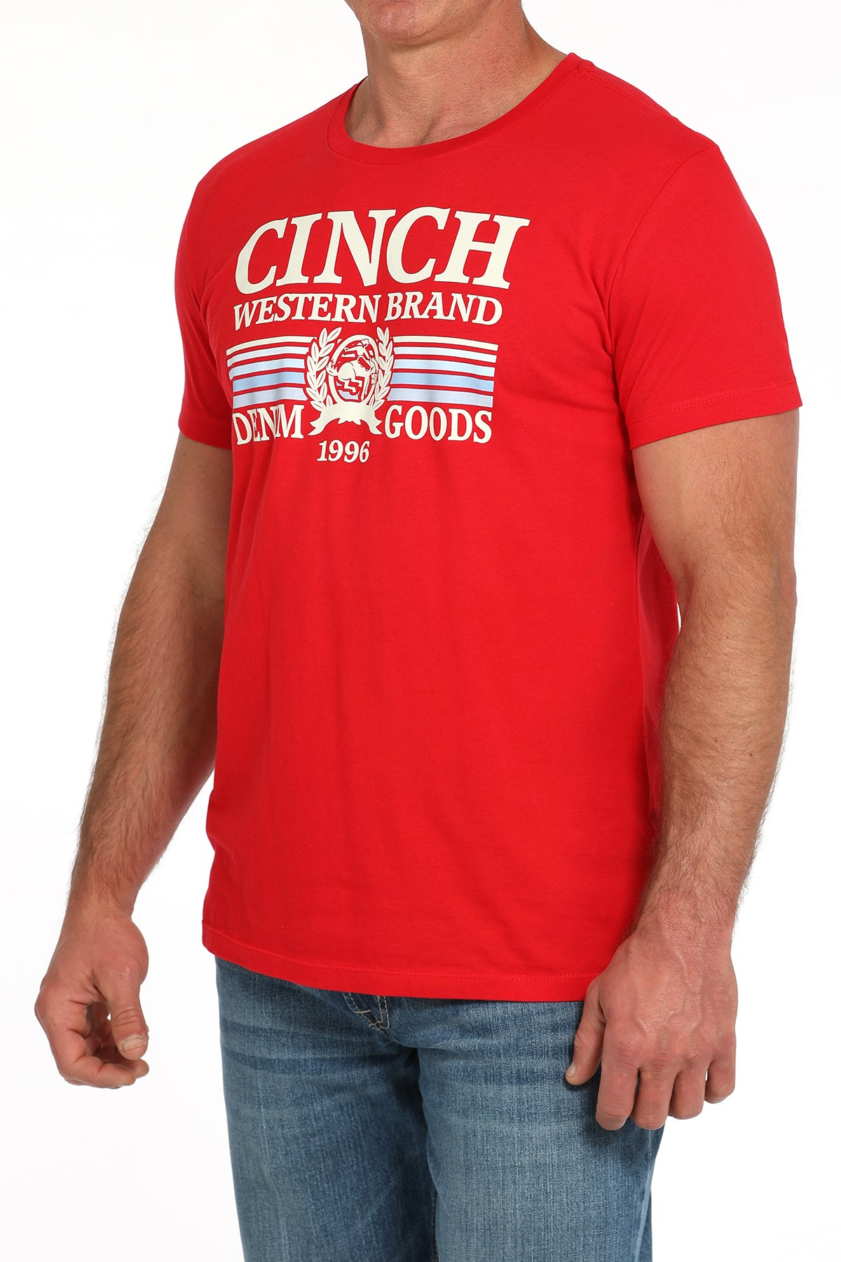 Man wearing a red t-shirt with a large 'Cinch' graphic on the front and blue jeans on a white background