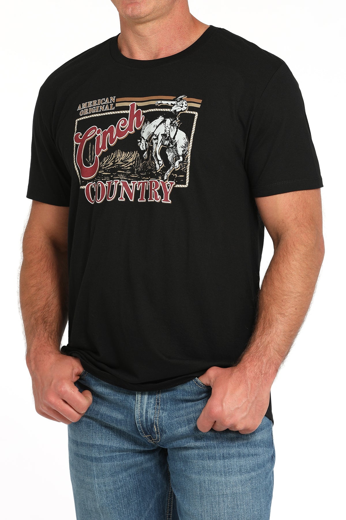 Man wearing a black t-shirt with a large 'Cinch' graphic on the front and blue jeans on a white background