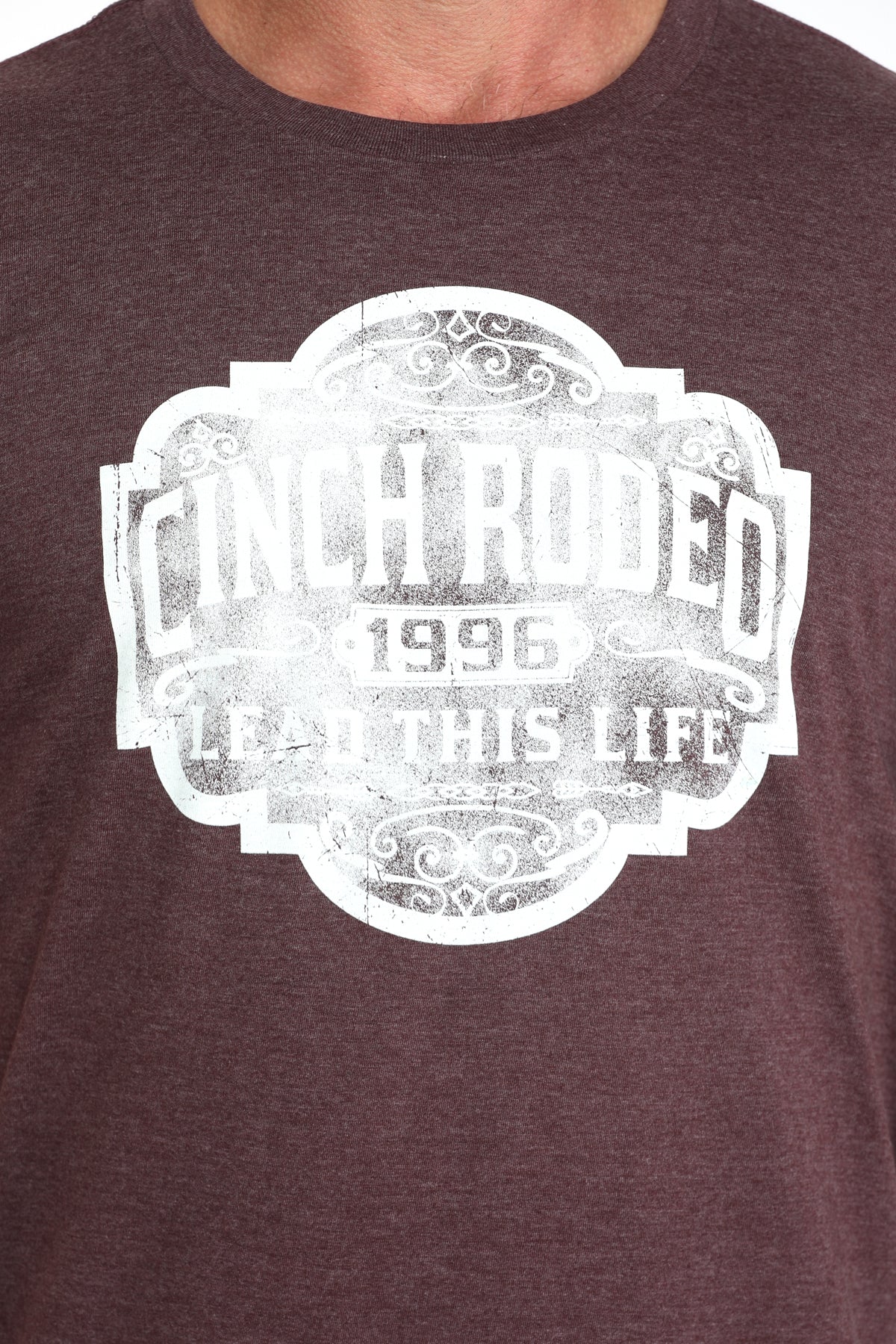 Brown t-shirt with white graphic design and text on a plain background