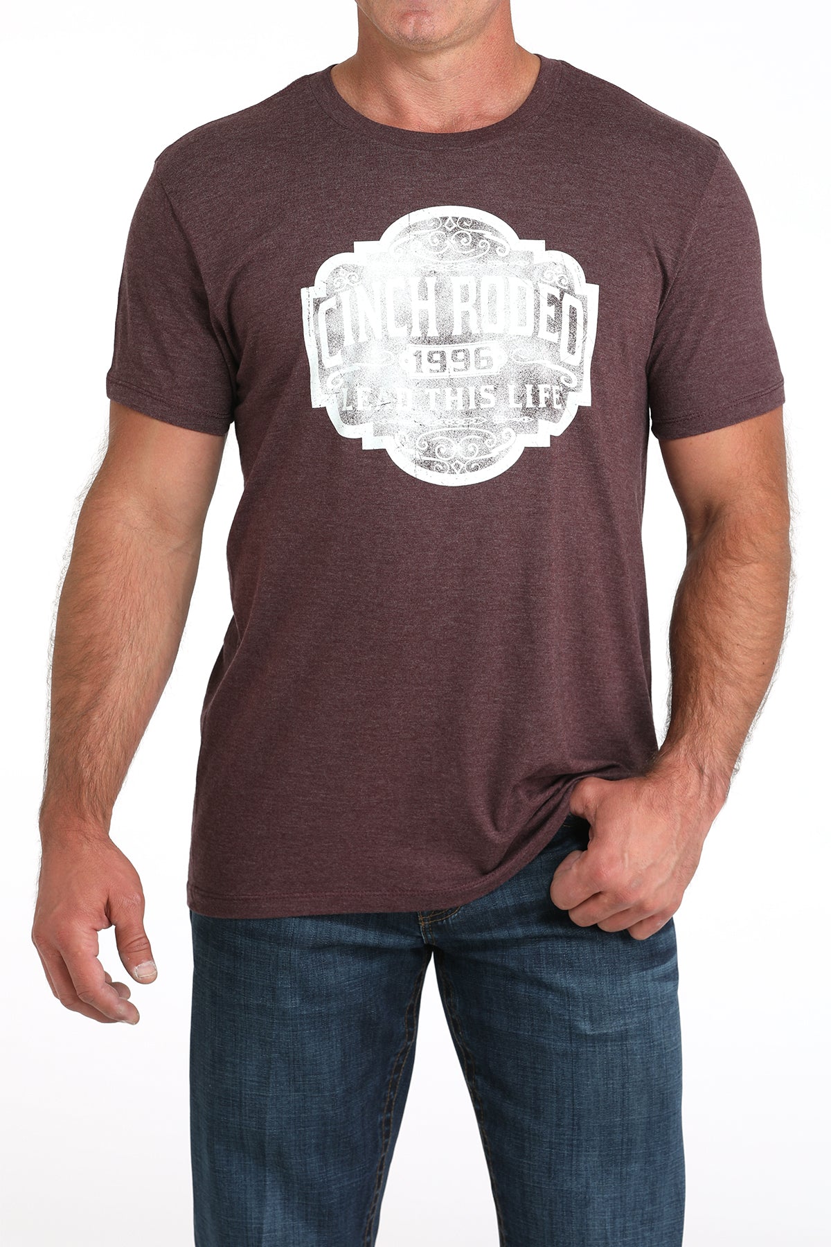 Man wearing a brown t-shirt with a white graphic design on a white background
