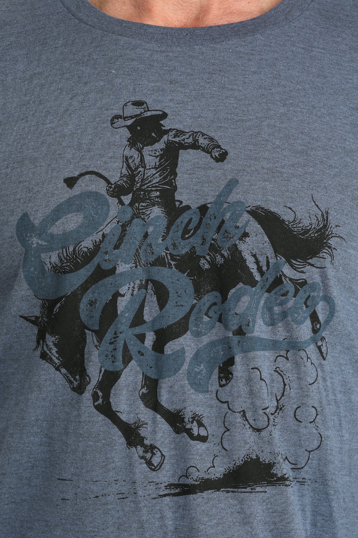 Gray t-shirt with a graphic of a cowboy riding a horse and the text 'Cowboy Rides'.