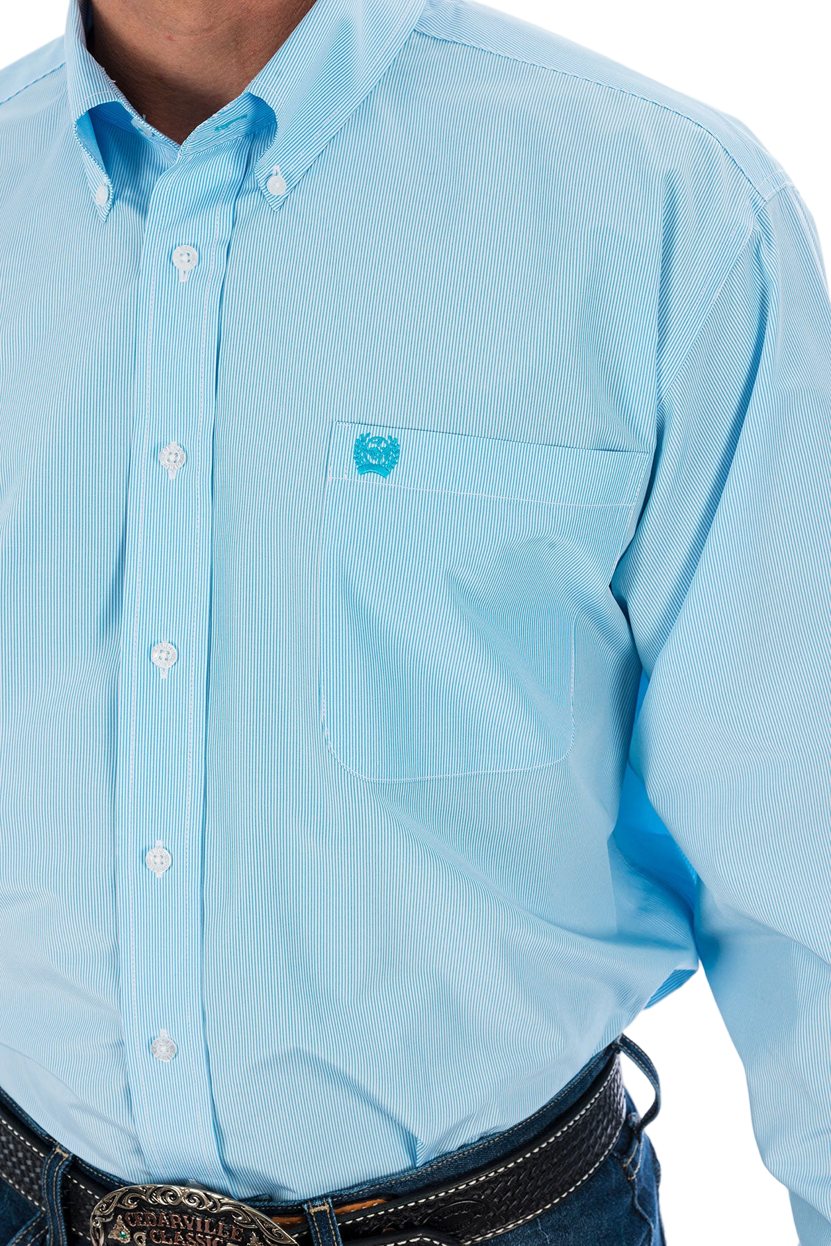 Close-up of a man wearing a light blue button-up shirt and blue jeans on a white background