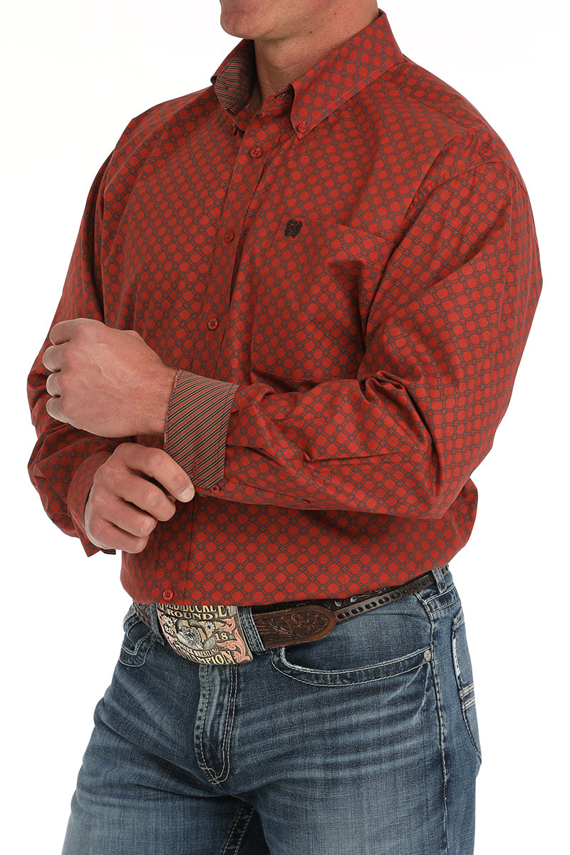 Man wearing a red long sleeve button-down with contrasting cuffs, paired with jeans and a belt