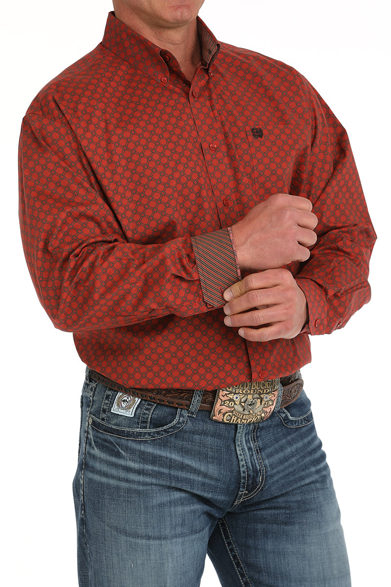 Man wearing a red long sleeve button-down with contrasting cuffs, paired with jeans and a belt