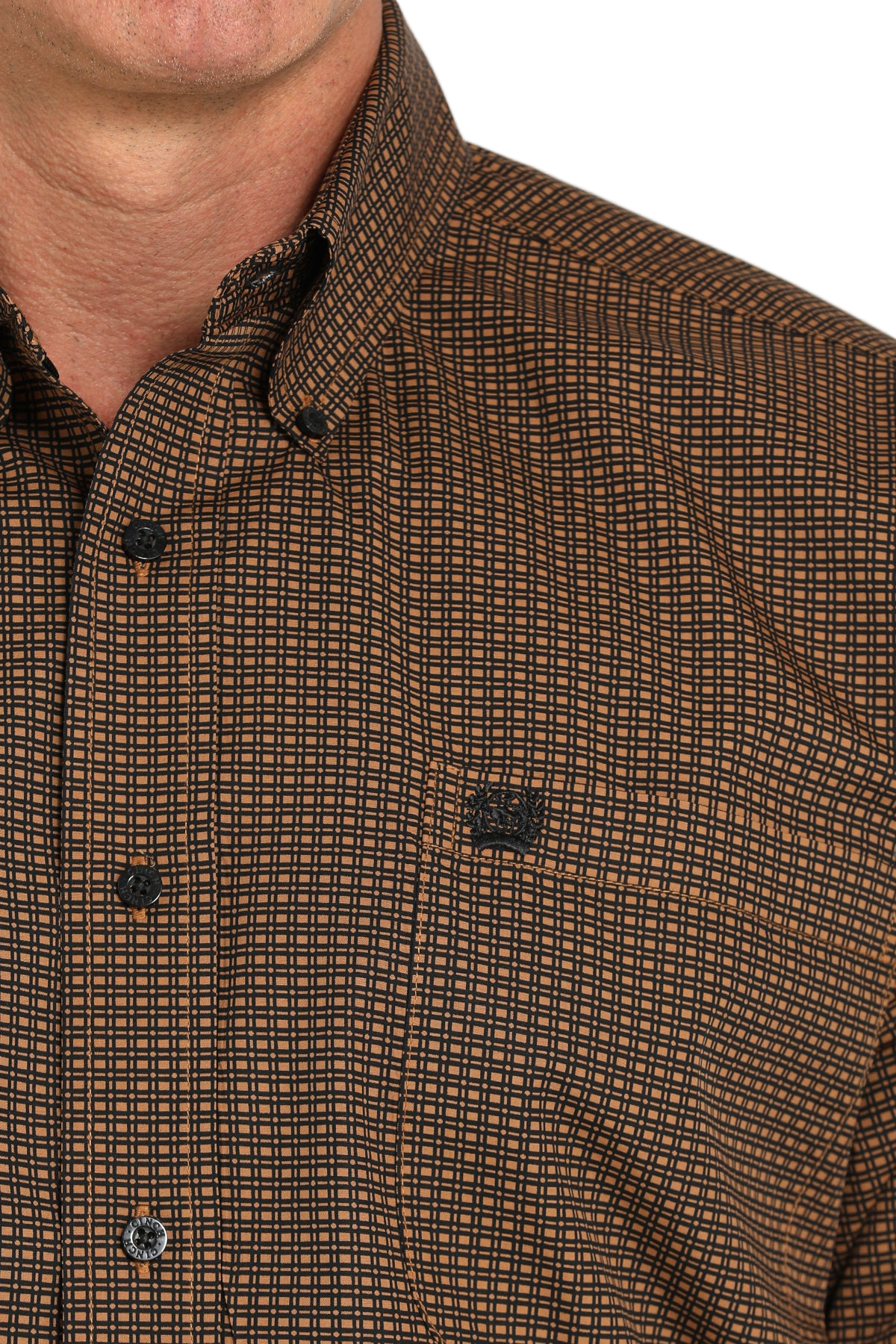 Close-up of a man wearing a patterned brown long sleeve button-down shirt on a transparent background