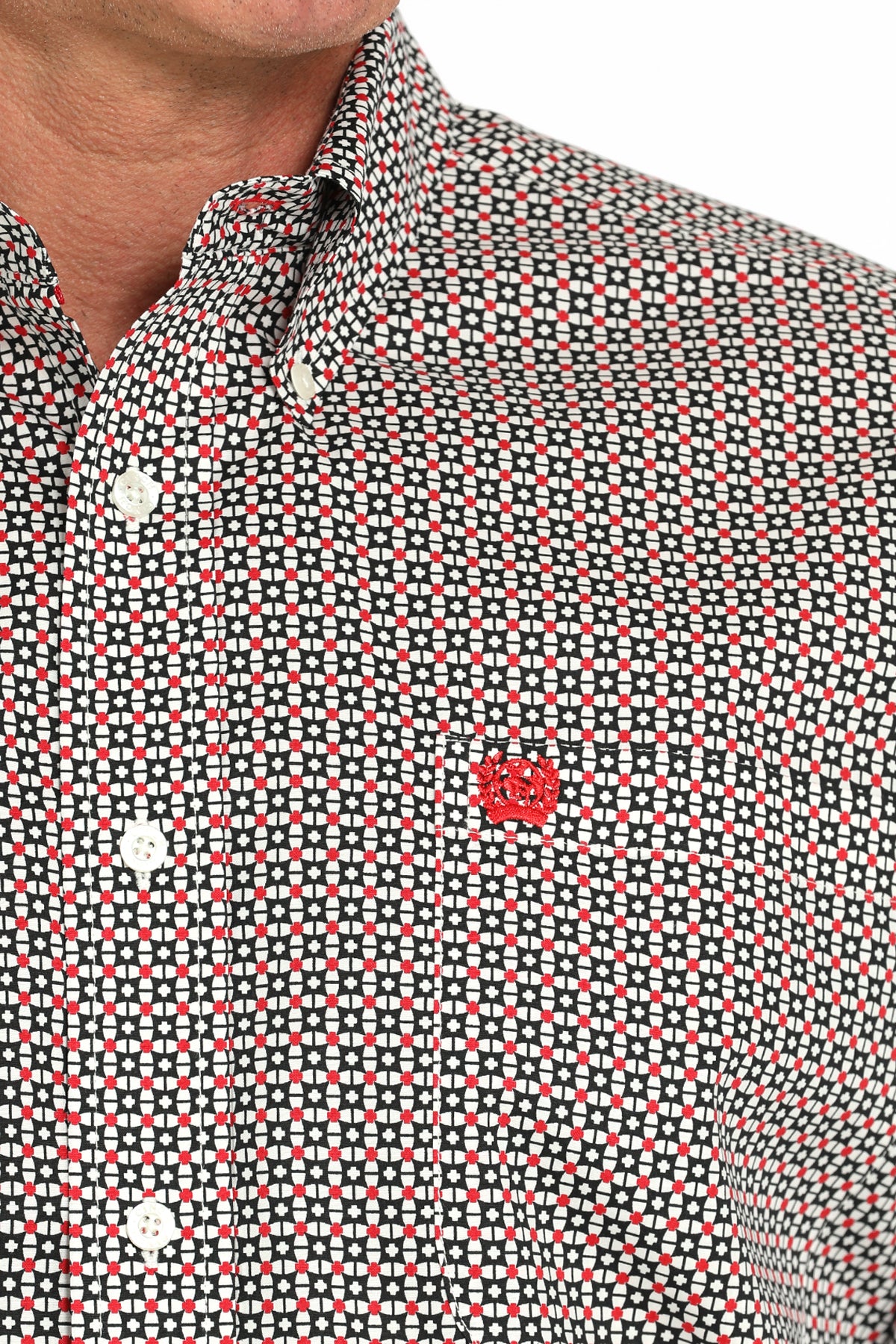 Close-up of a man wearing a patterned long sleeve button-down shirt