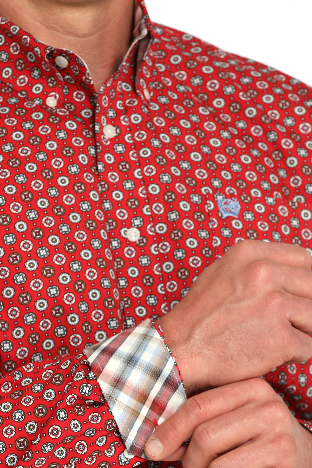 Close-up of a man wearing a red long sleeve button-down with contrasting cuffs