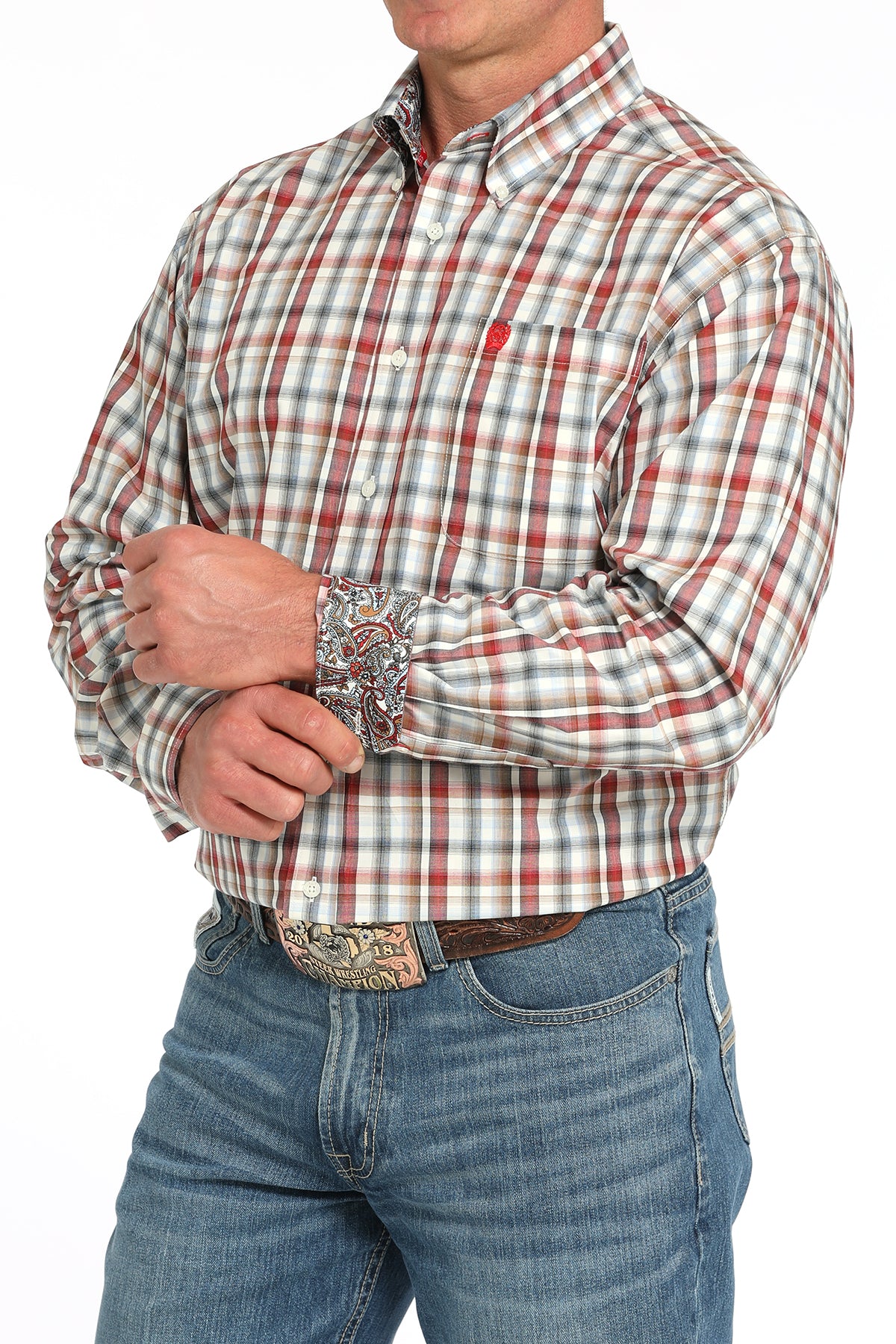Man wearing a plaid long sleeve button-down shirt with contrasting cuffs, paired with jeans and a belt