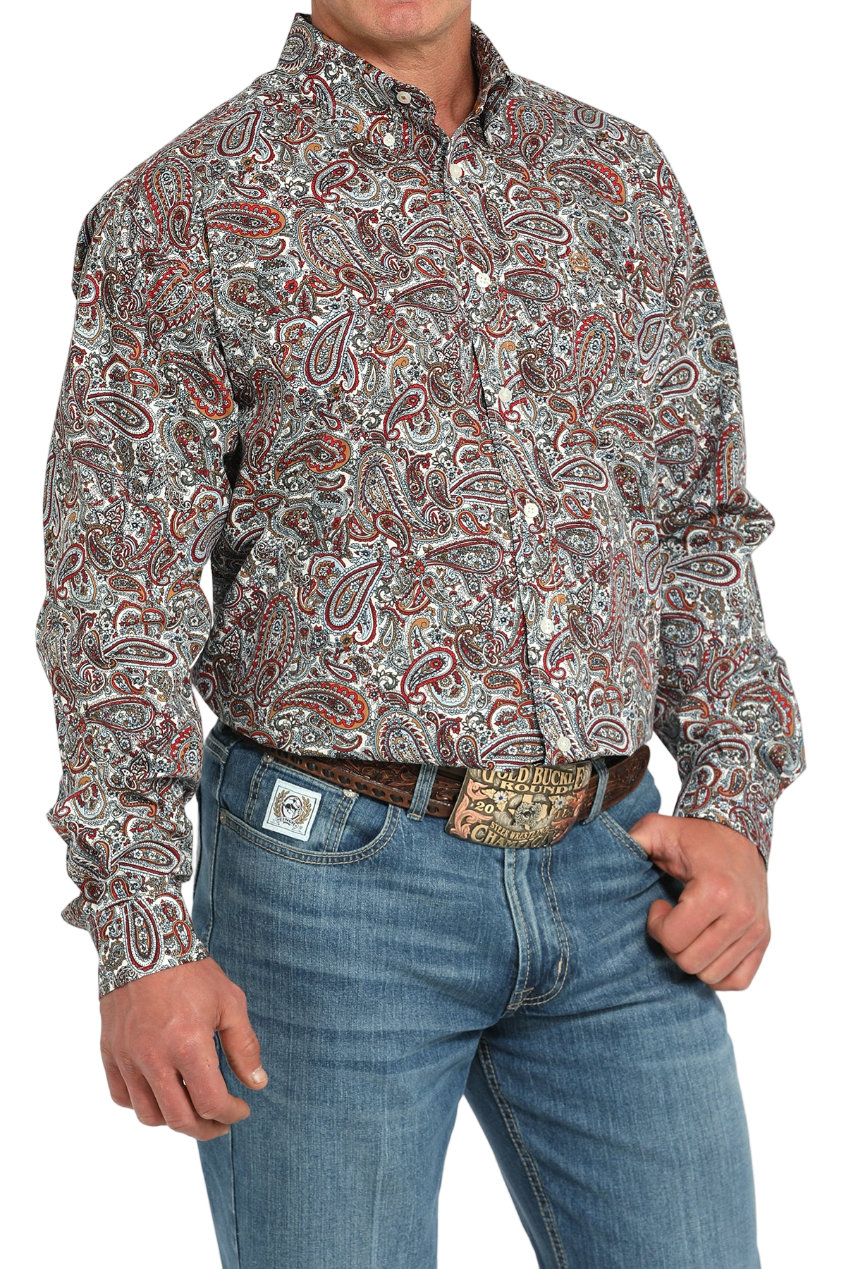 Man wearing a patterned multi-color long sleeve button-down shirt and jeans on a transparent background