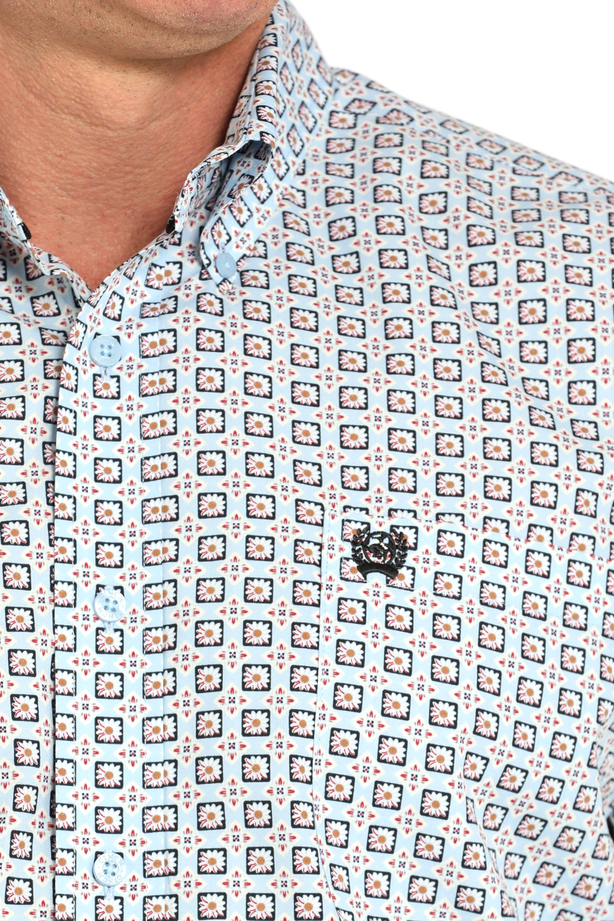 Close-up of a man wearing a patterned long sleeve button-down shirt