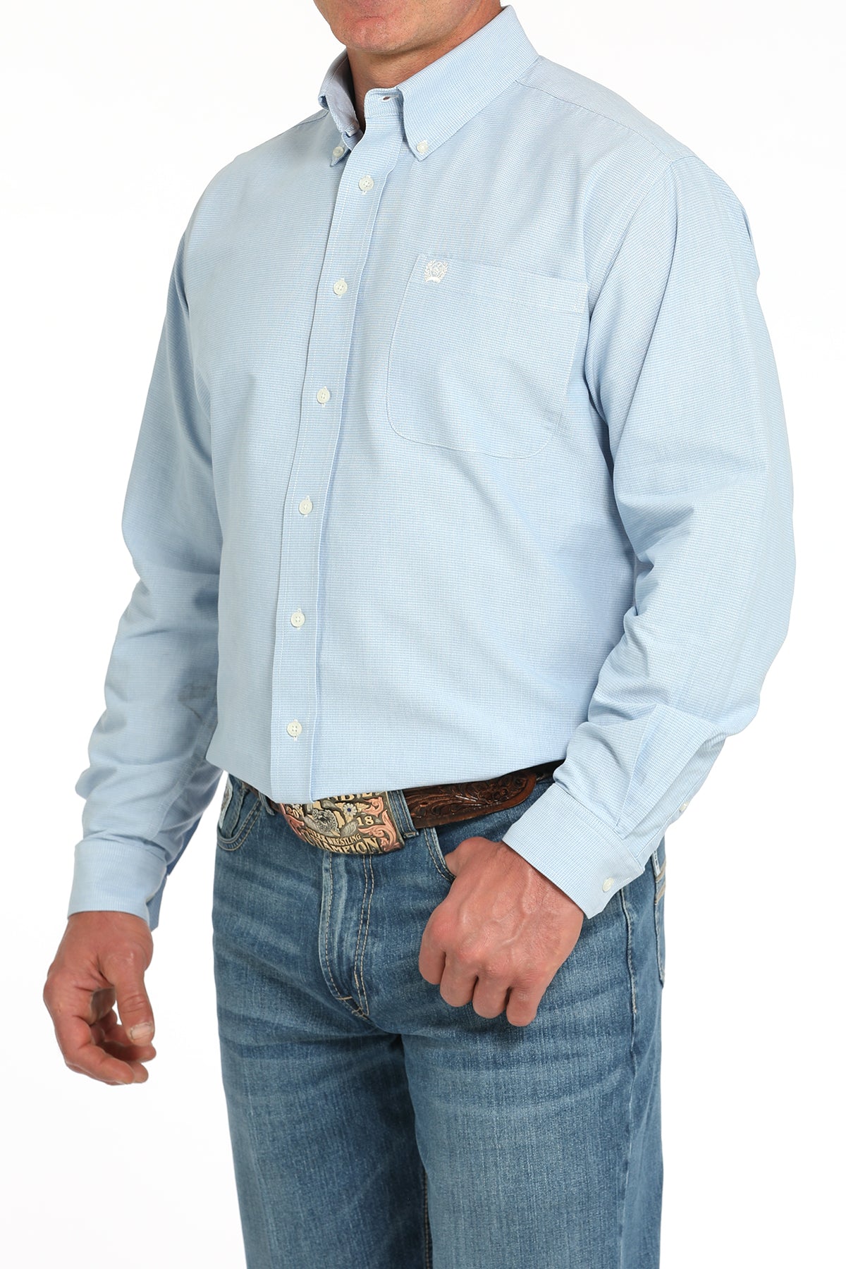 Light blue button-up shirt worn by a person on a white background