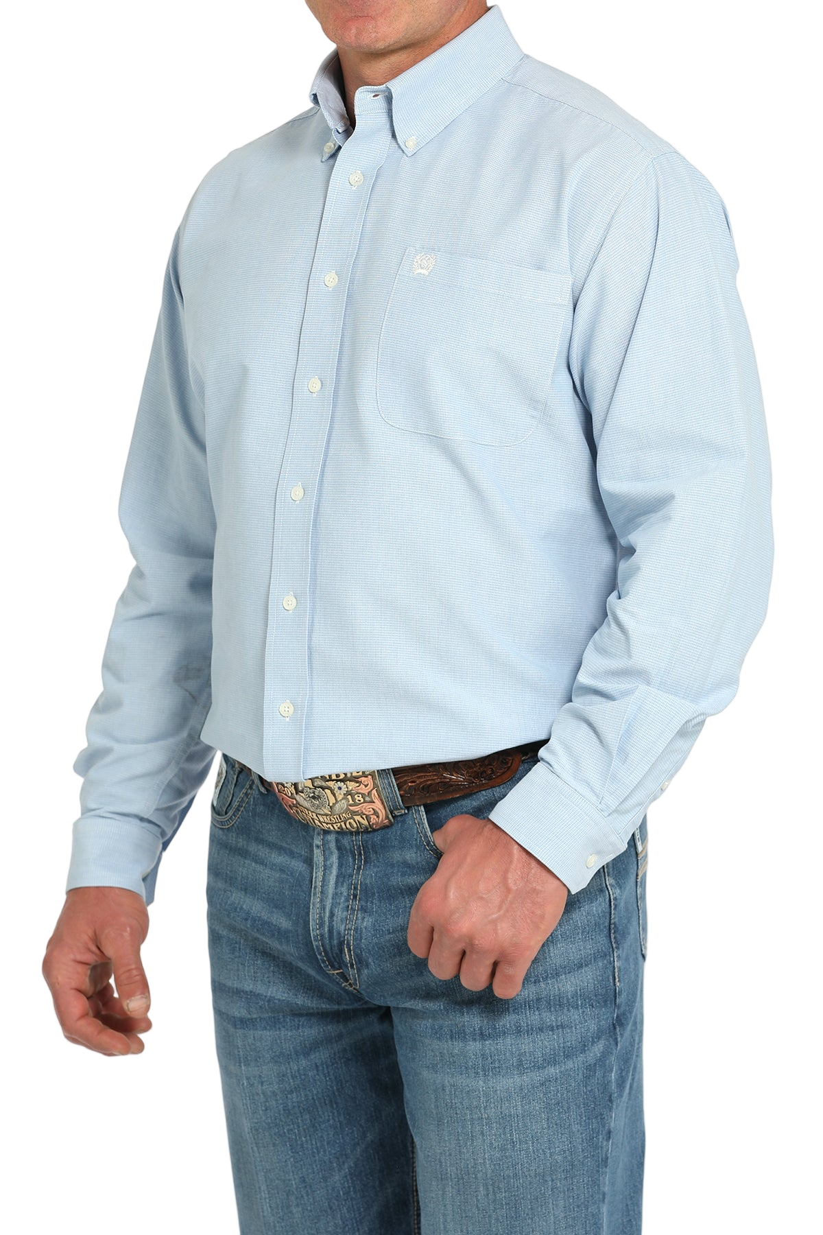 Man wearing a light blue button-up shirt with blue jeans on a white background