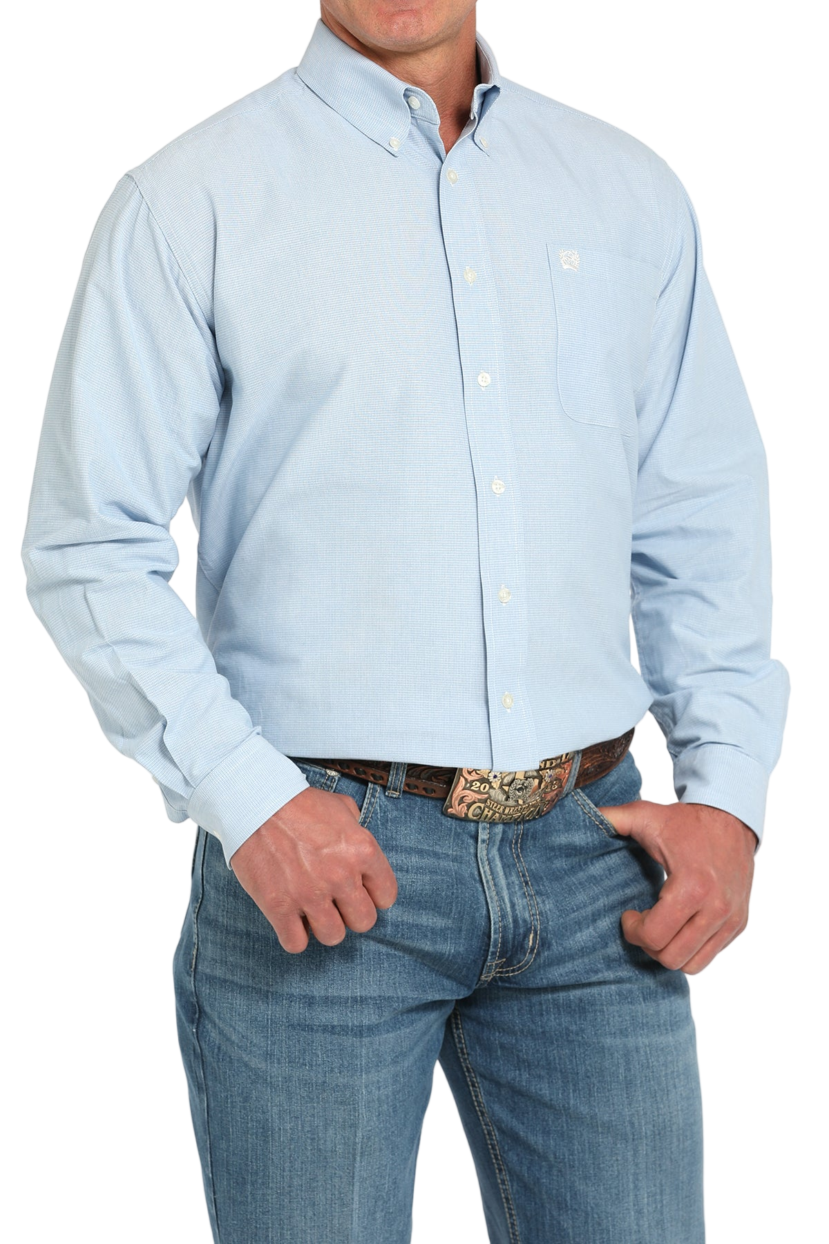Man wearing a light blue button-up shirt with blue jeans on a white background