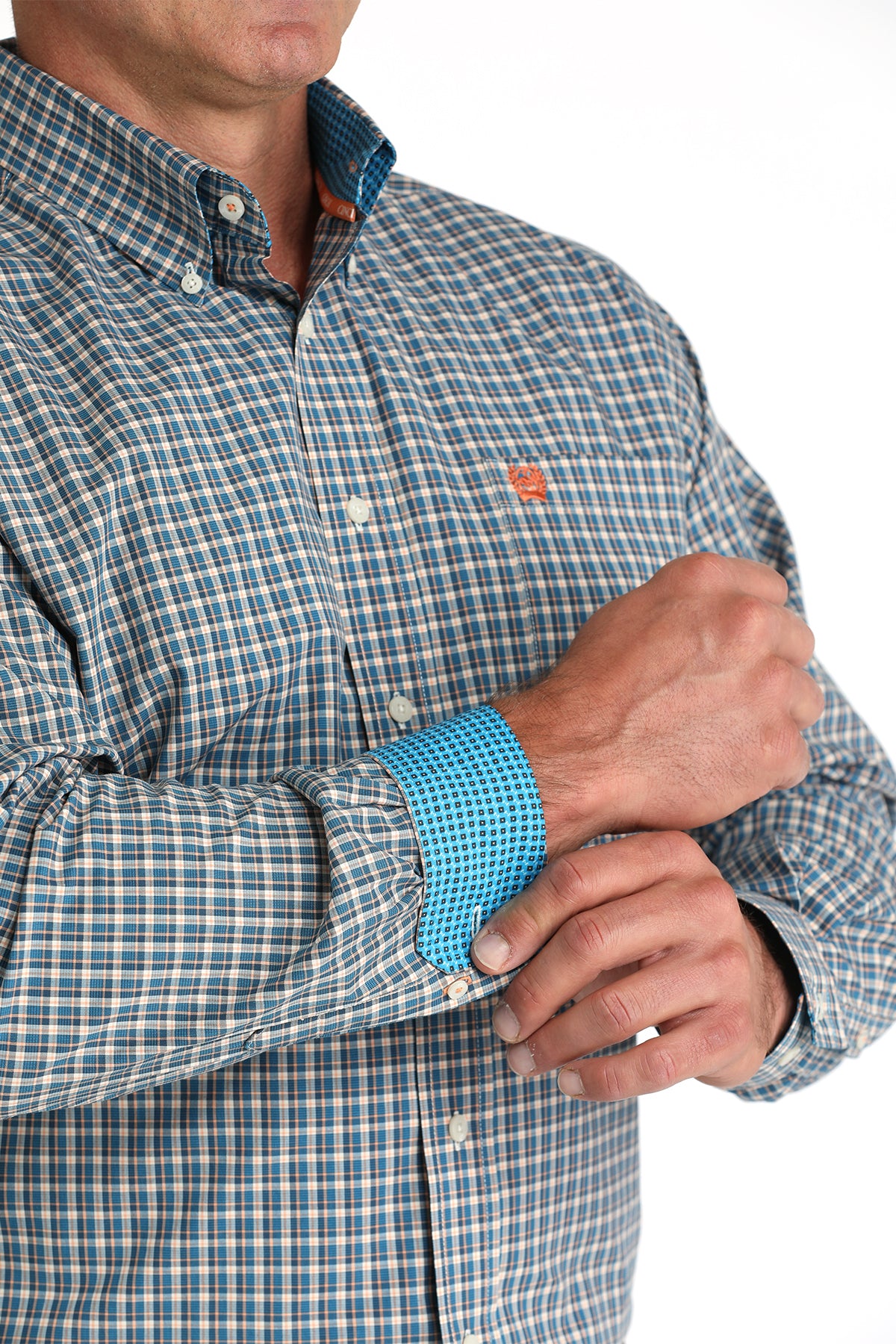 Close-up of a person wearing a checkered shirt with rolled-up sleeves, focusing on the sleeve and shirt collar.