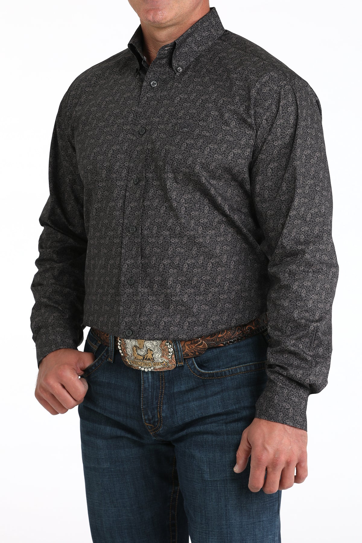 Man wearing a dark gray long sleeve button-down shirt with jeans and a belt