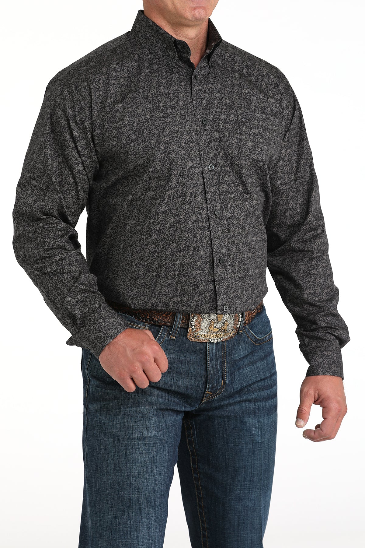 Man wearing a dark gray long sleeve button-down shirt with jeans and a belt