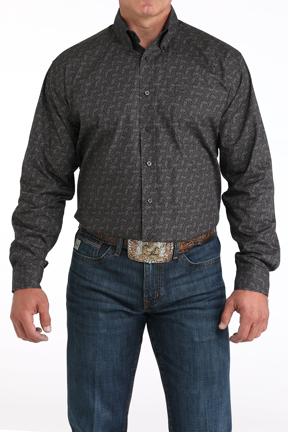 Man wearing a dark gray long sleeve button-down shirt with jeans and a belt