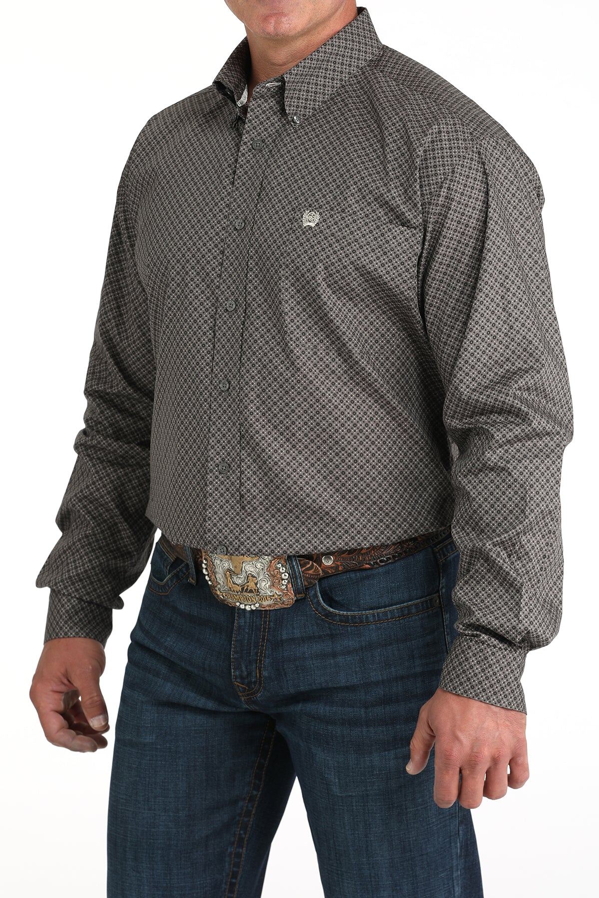 Man wearing a patterned long-sleeve shirt and jeans on a white background