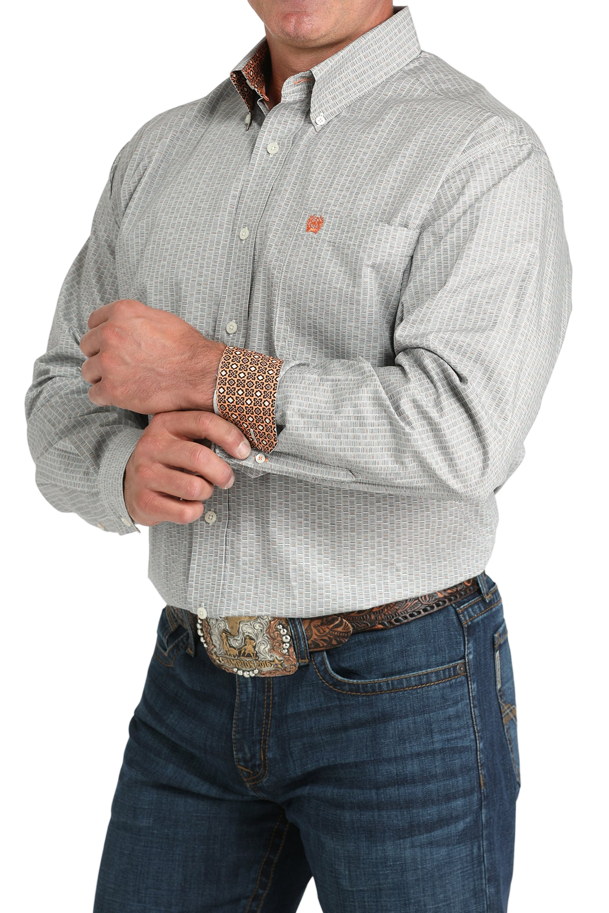 Man wearing a patterned gray long sleeve button-down shirt with contrasting cuffs and jeans on a transparent background