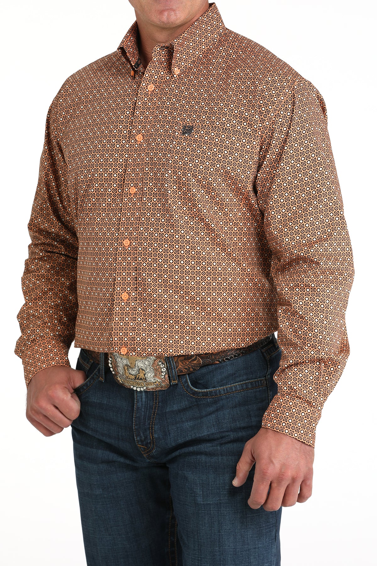 Man wearing a patterned brown shirt and jeans on a white background