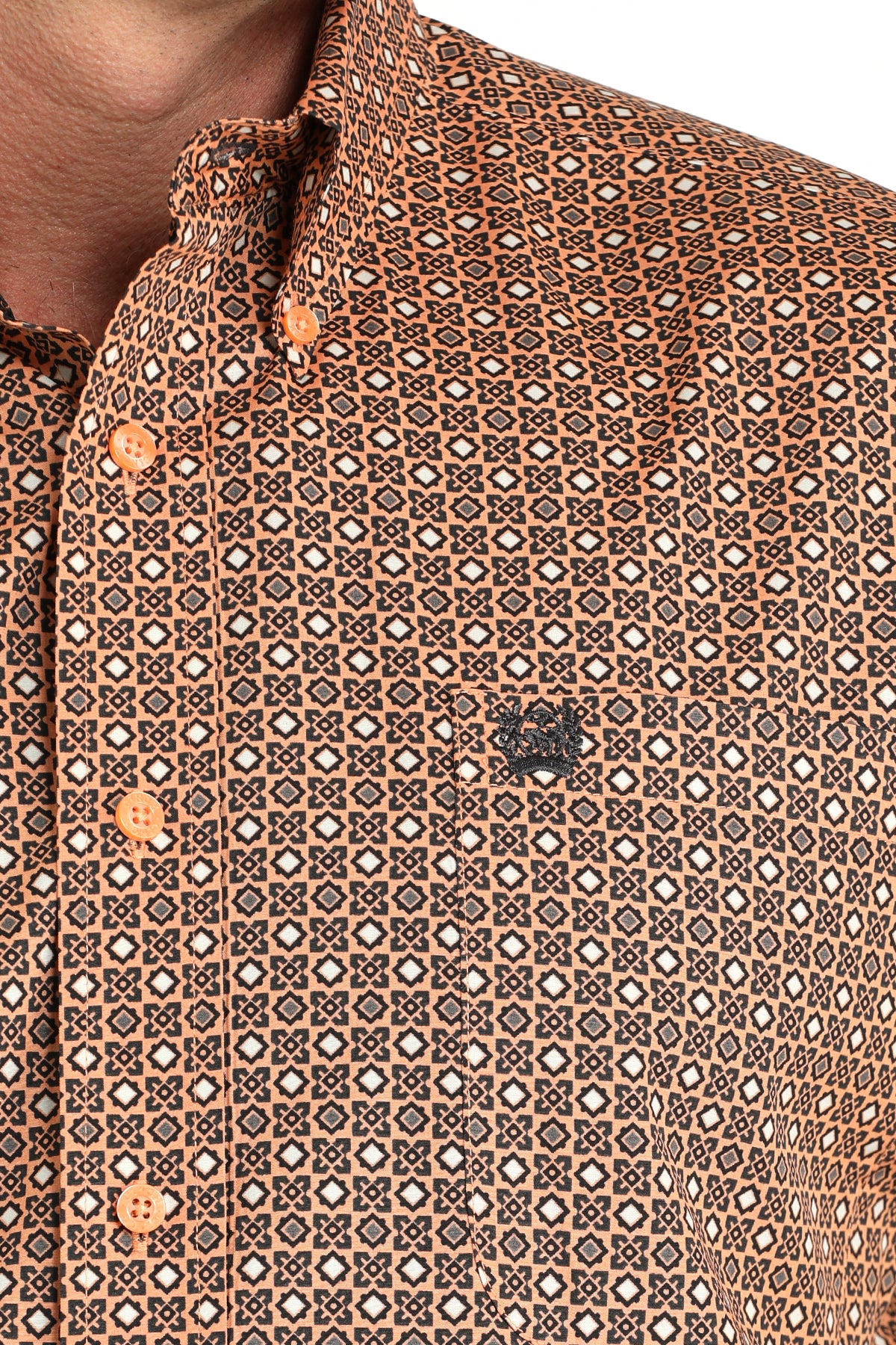 Close-up of a patterned shirt with a focus on the collar and buttons.