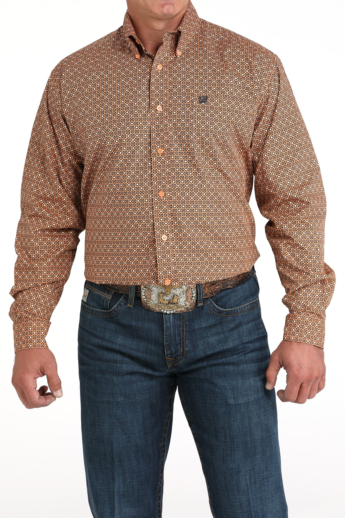 Man wearing a patterned brown shirt and blue jeans on a white background