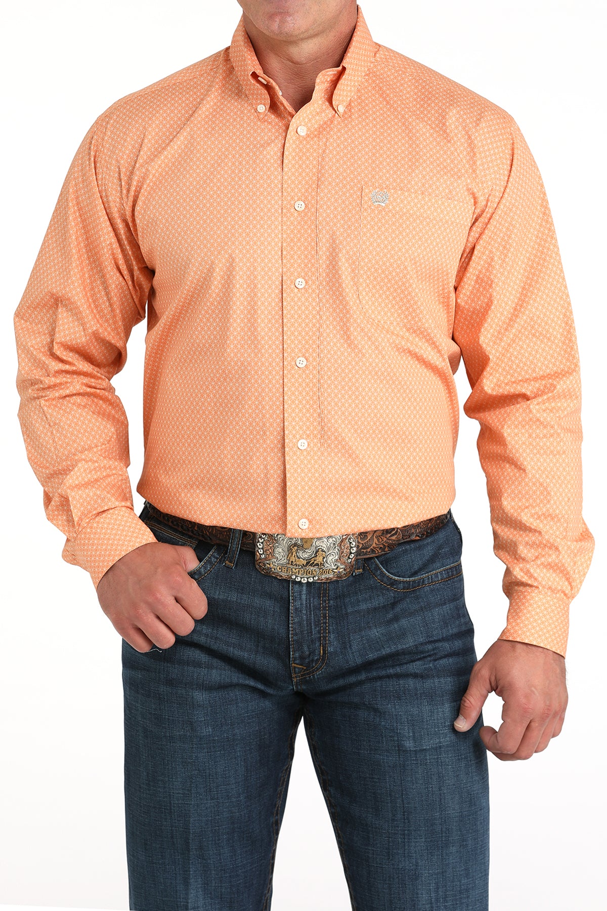 Man wearing an orange patterned shirt and blue jeans on a white background