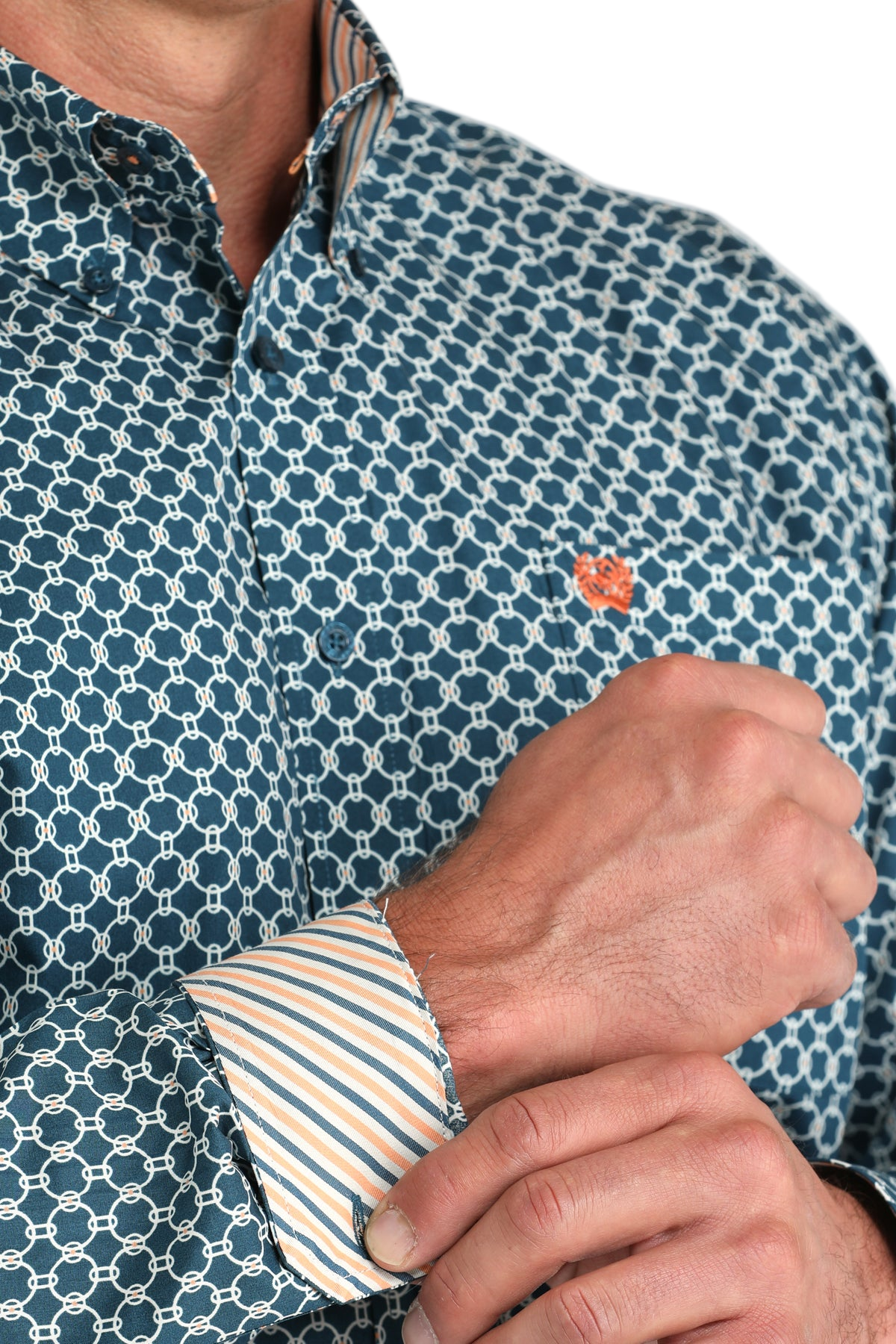 Close-up of a man wearing a patterned blue long sleeve button-down shirt with contrasting cuffs on a transparent background