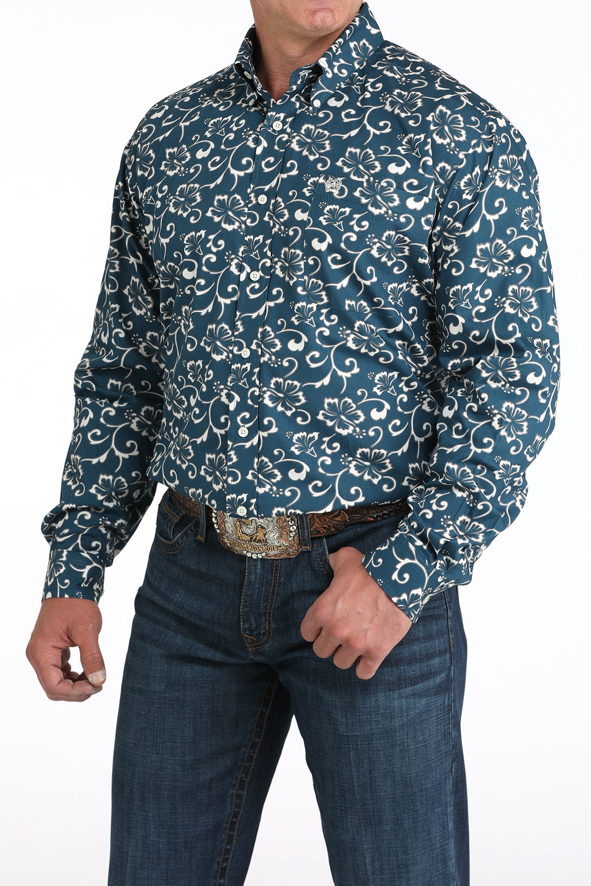 Man wearing a blue patterned shirt and jeans on a white background