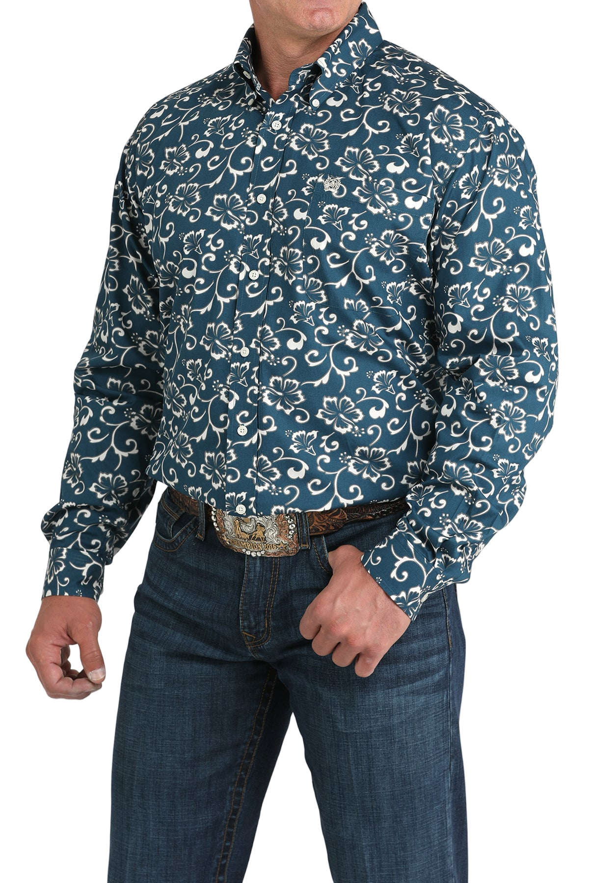 Man wearing a blue patterned button-up shirt with blue jeans on a white background