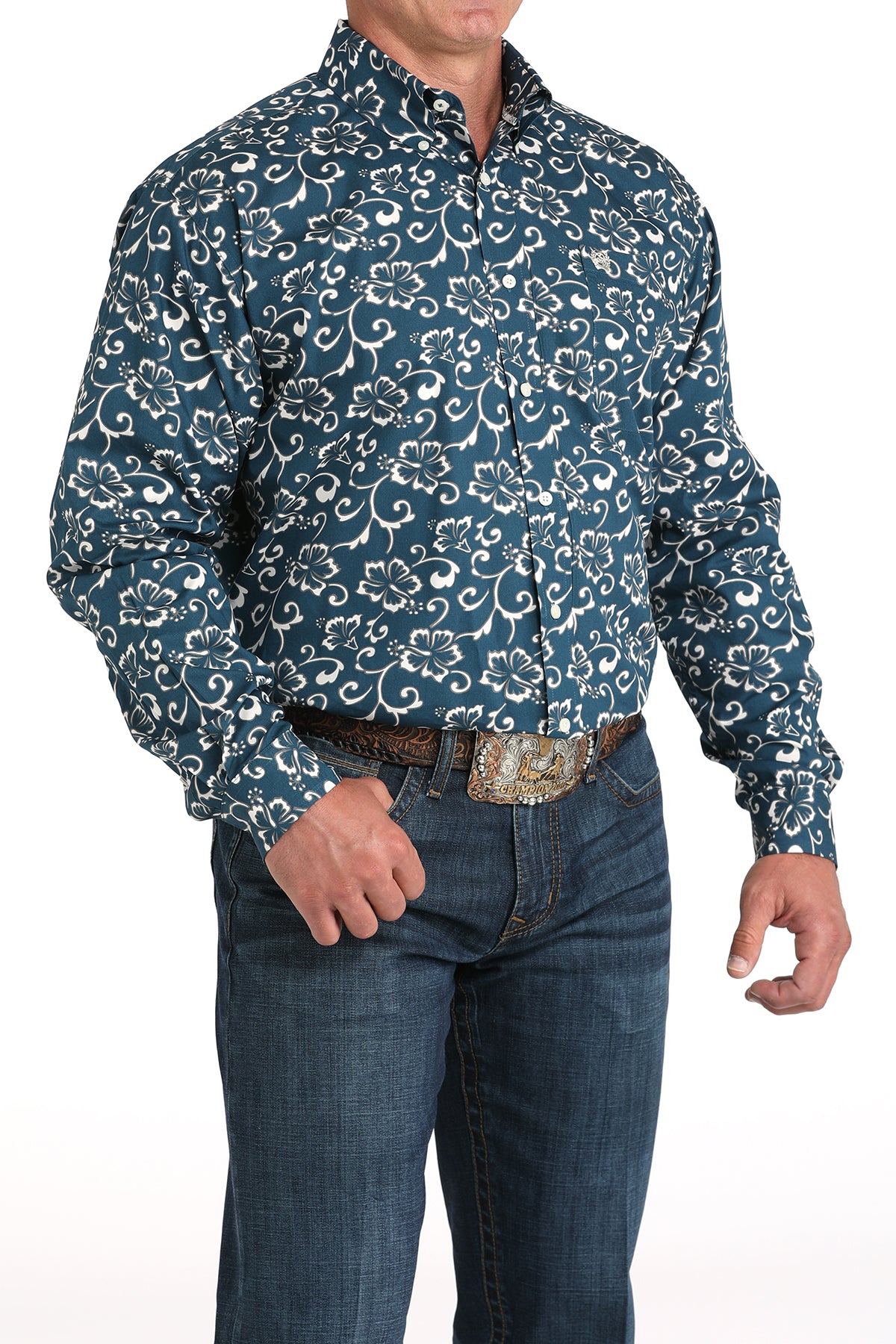 Man wearing a blue floral patterned shirt and jeans on a white background