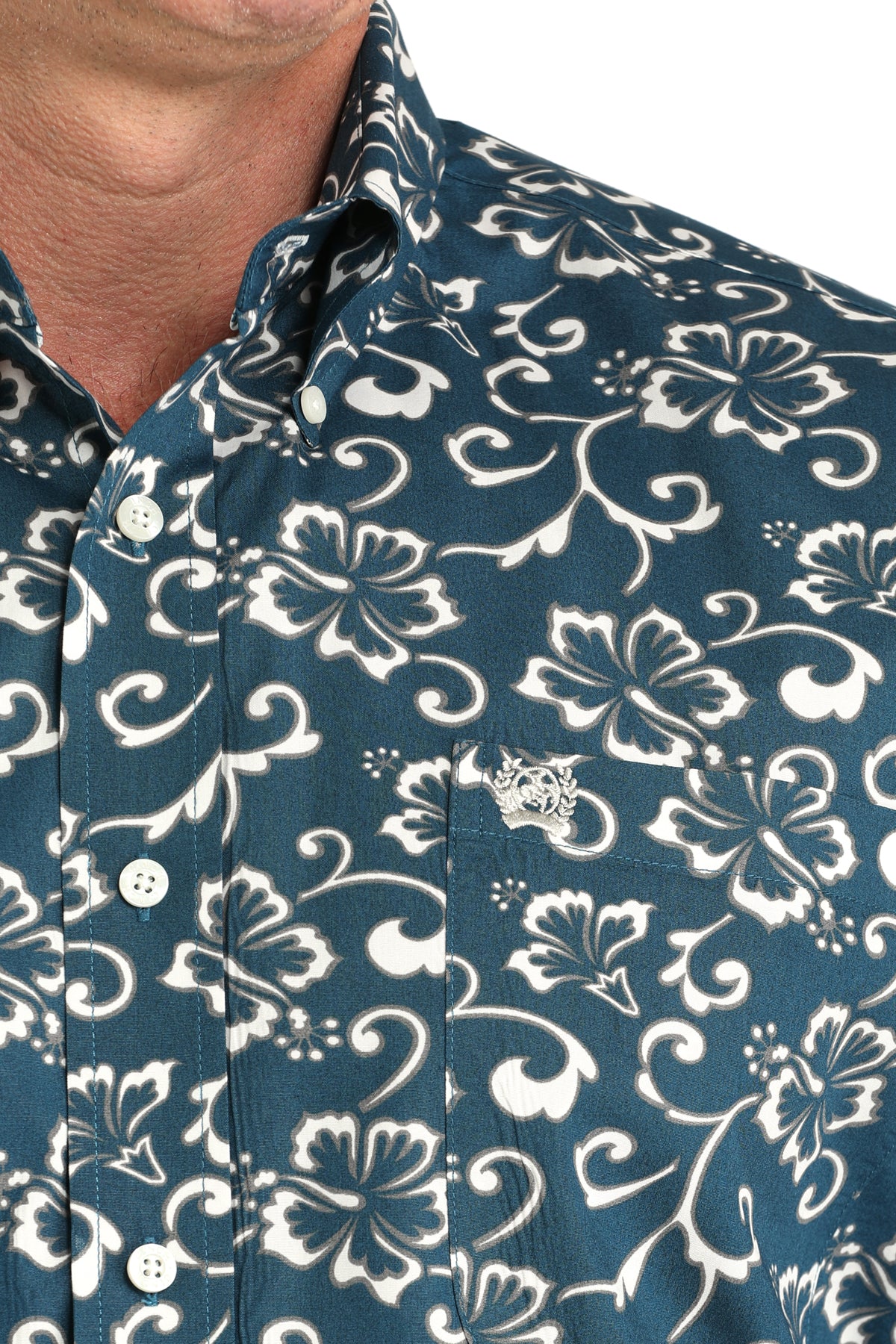 Close-up of a blue shirt with white floral pattern