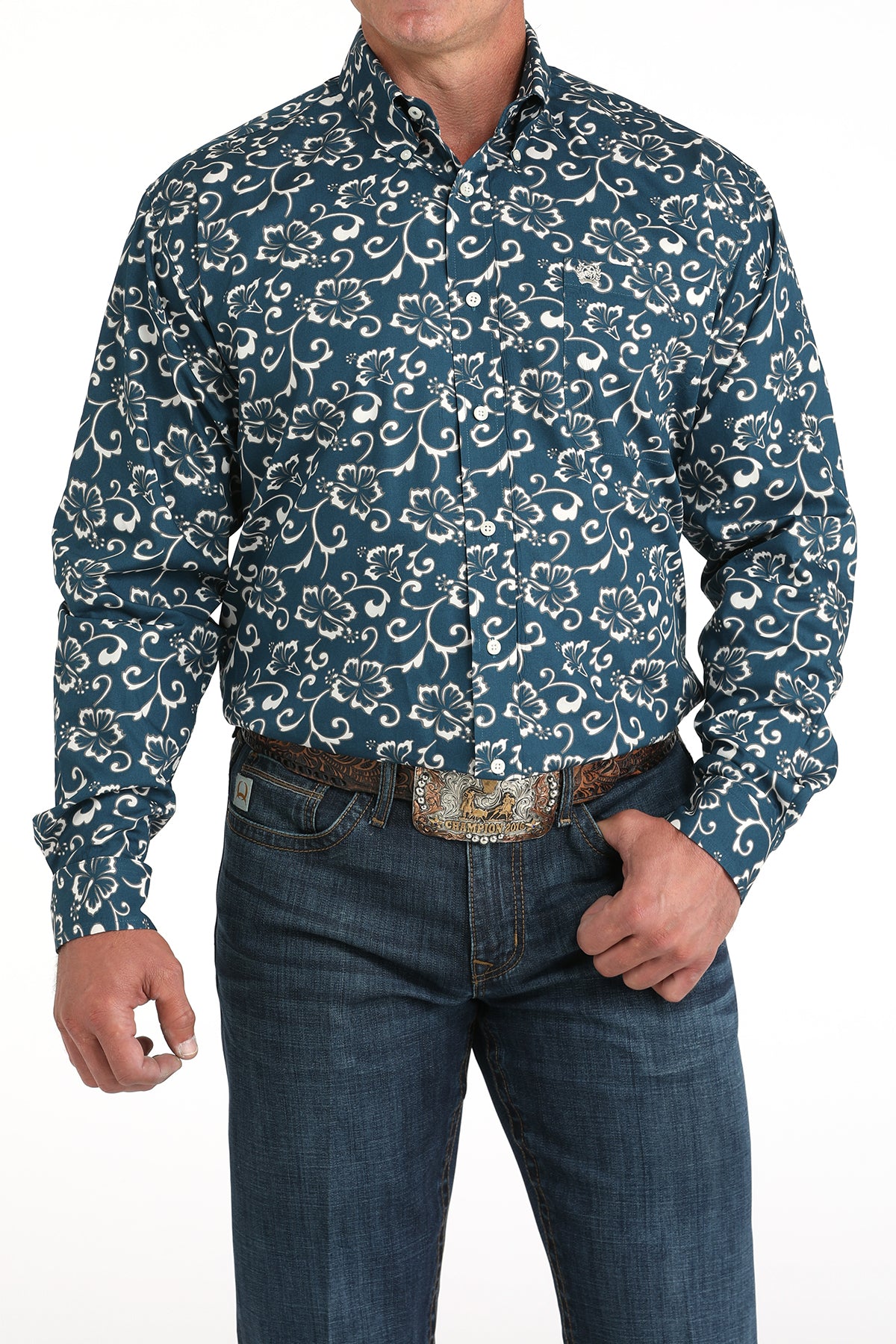 Man wearing a blue patterned shirt and jeans on a white background