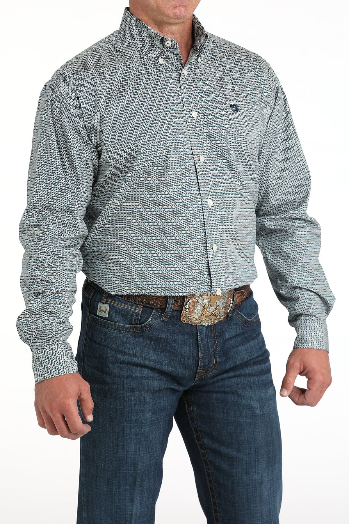Man wearing a patterned button-up shirt and jeans on a white background